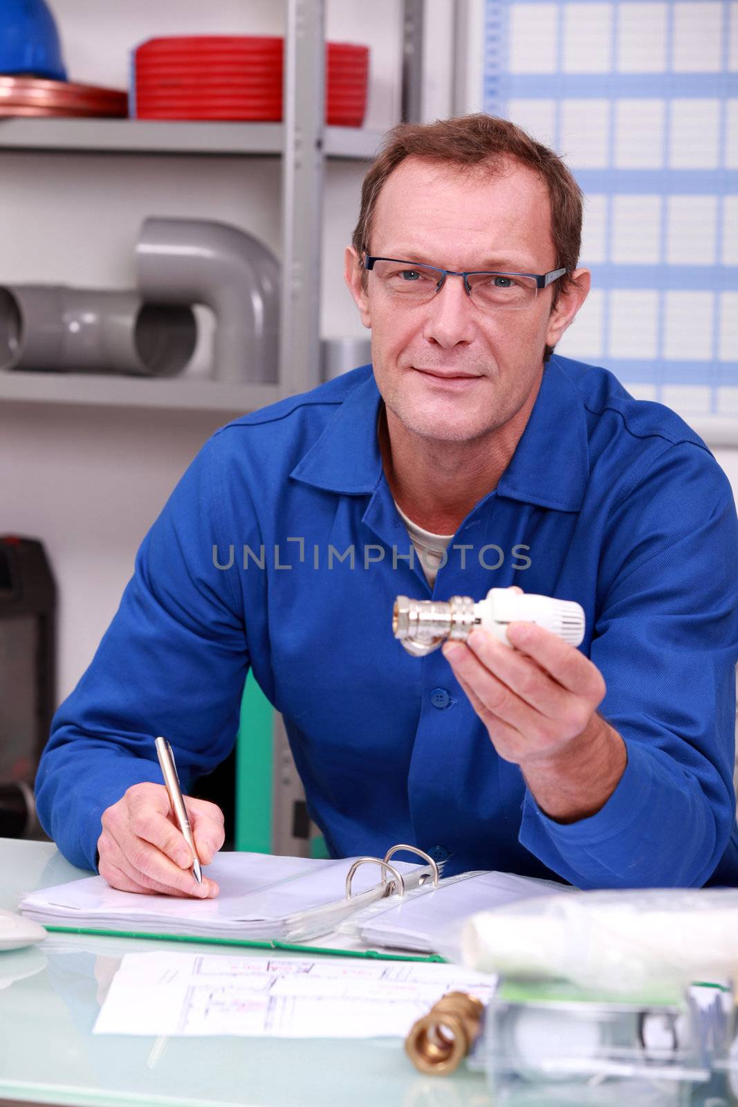 Construction worker keeping a log of the inventory by phovoir