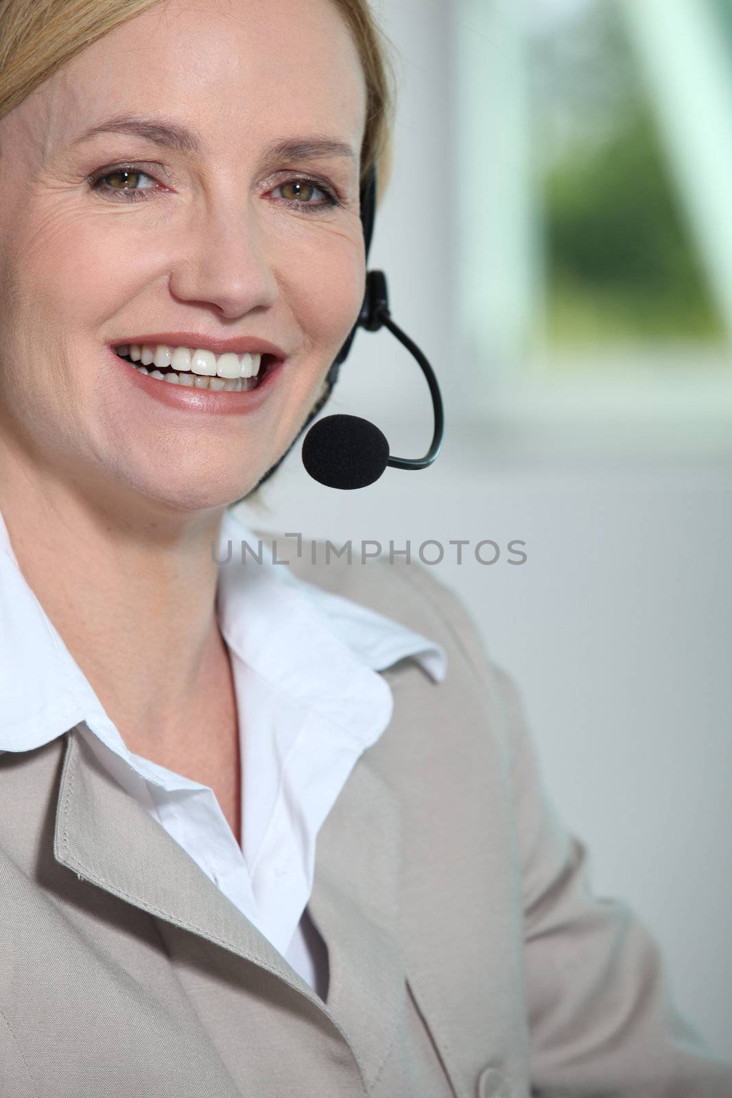 Woman laughing with headset. by phovoir