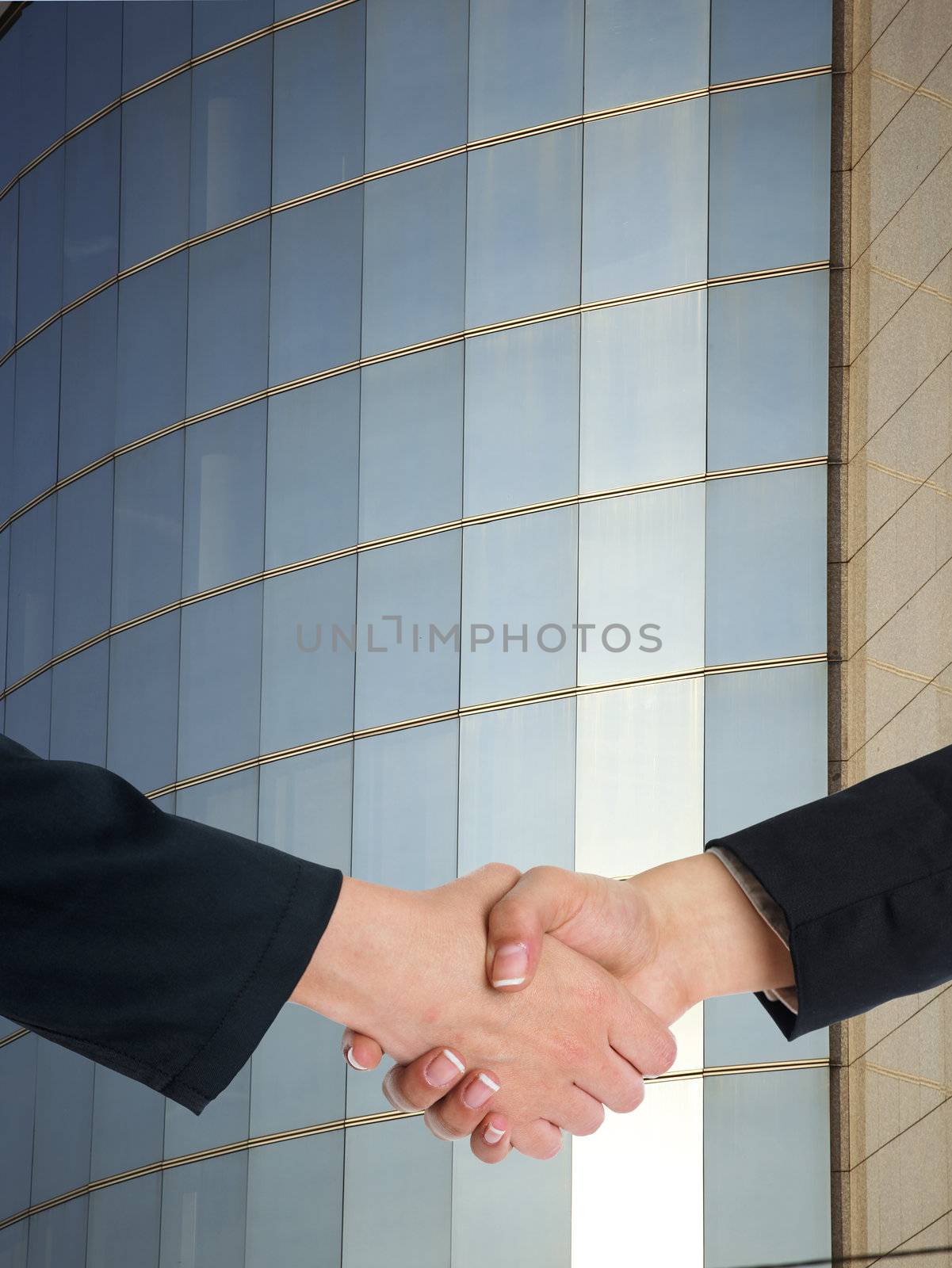 Architectural Handshaking in front of building by adamr