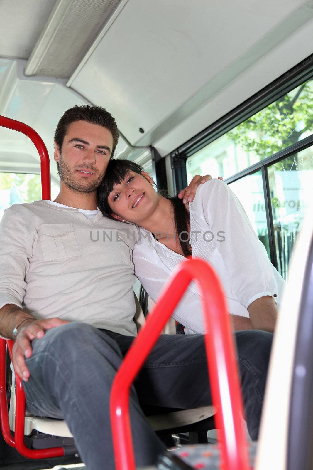 Couple sitting on a bus by phovoir
