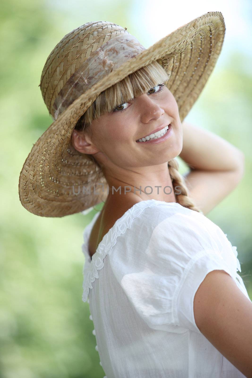 Woman smiling with straw hat by phovoir
