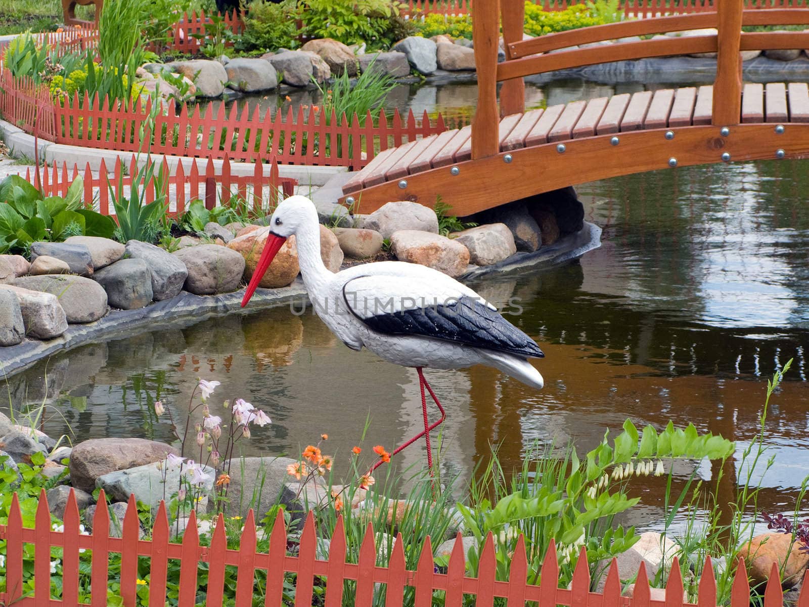 Beauty pond with bridge at park and bird in water