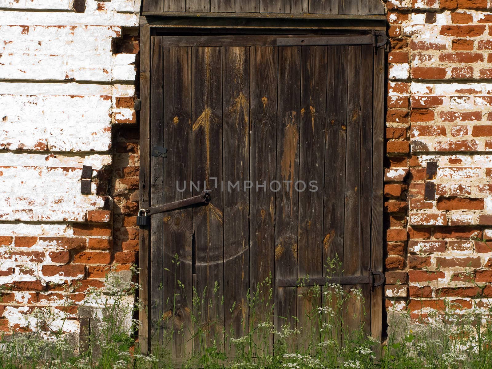 Old church closed entrance with wood door and lock