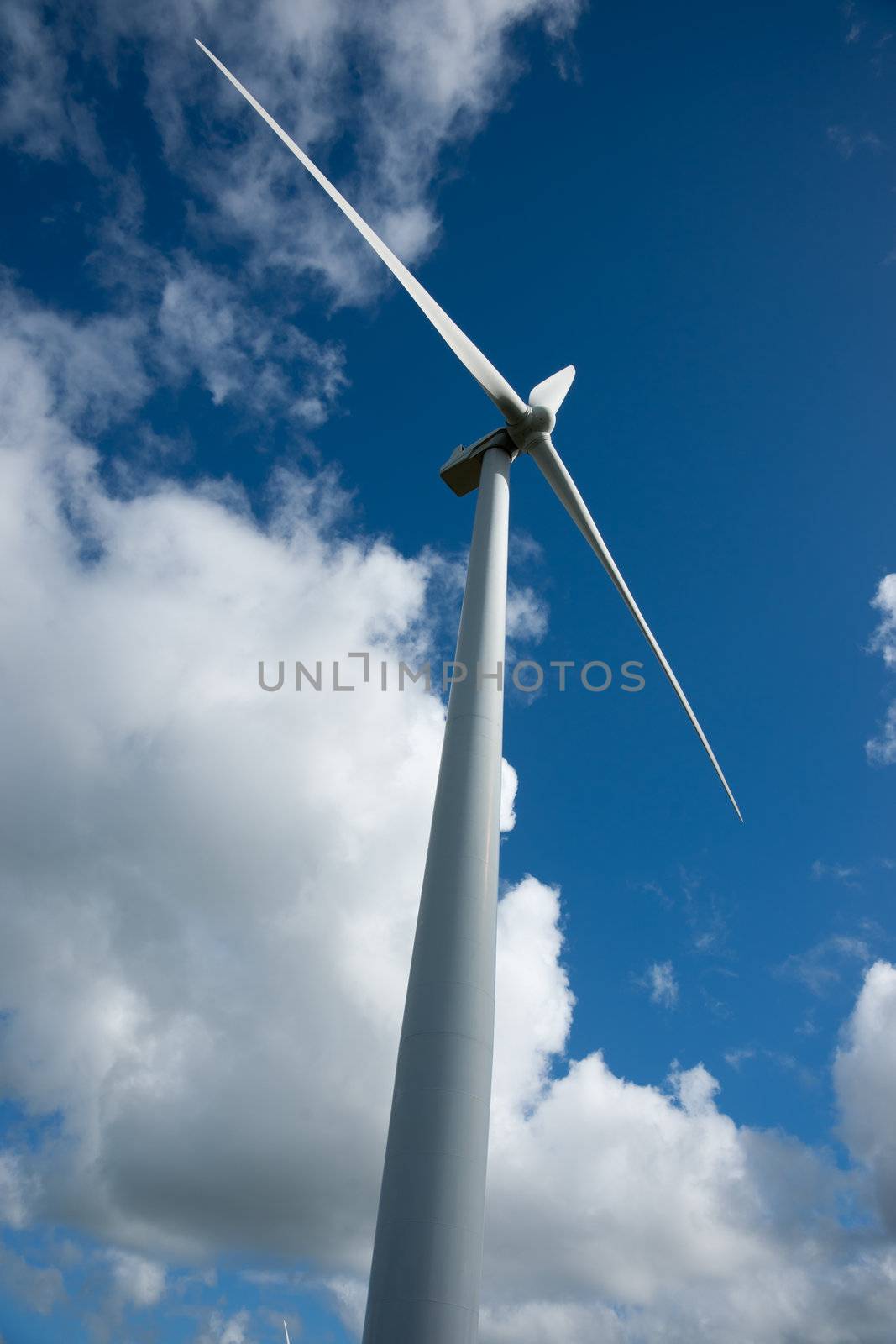 Wind turbine standing alone and revolving slowly.