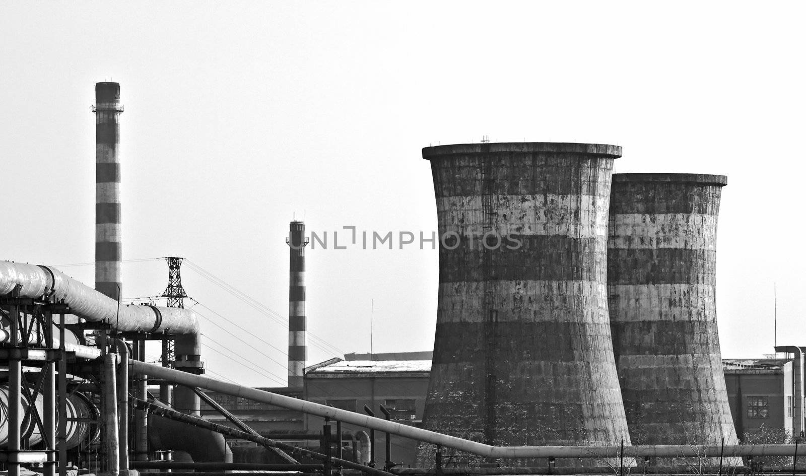Black & White landscape photo of factory with giant chimneys