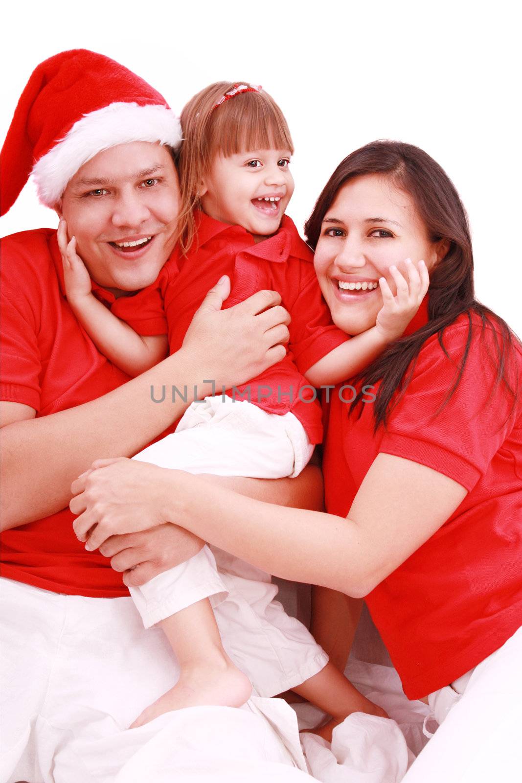 Portrait of happy family looking at camera and prepared for Chri by dacasdo