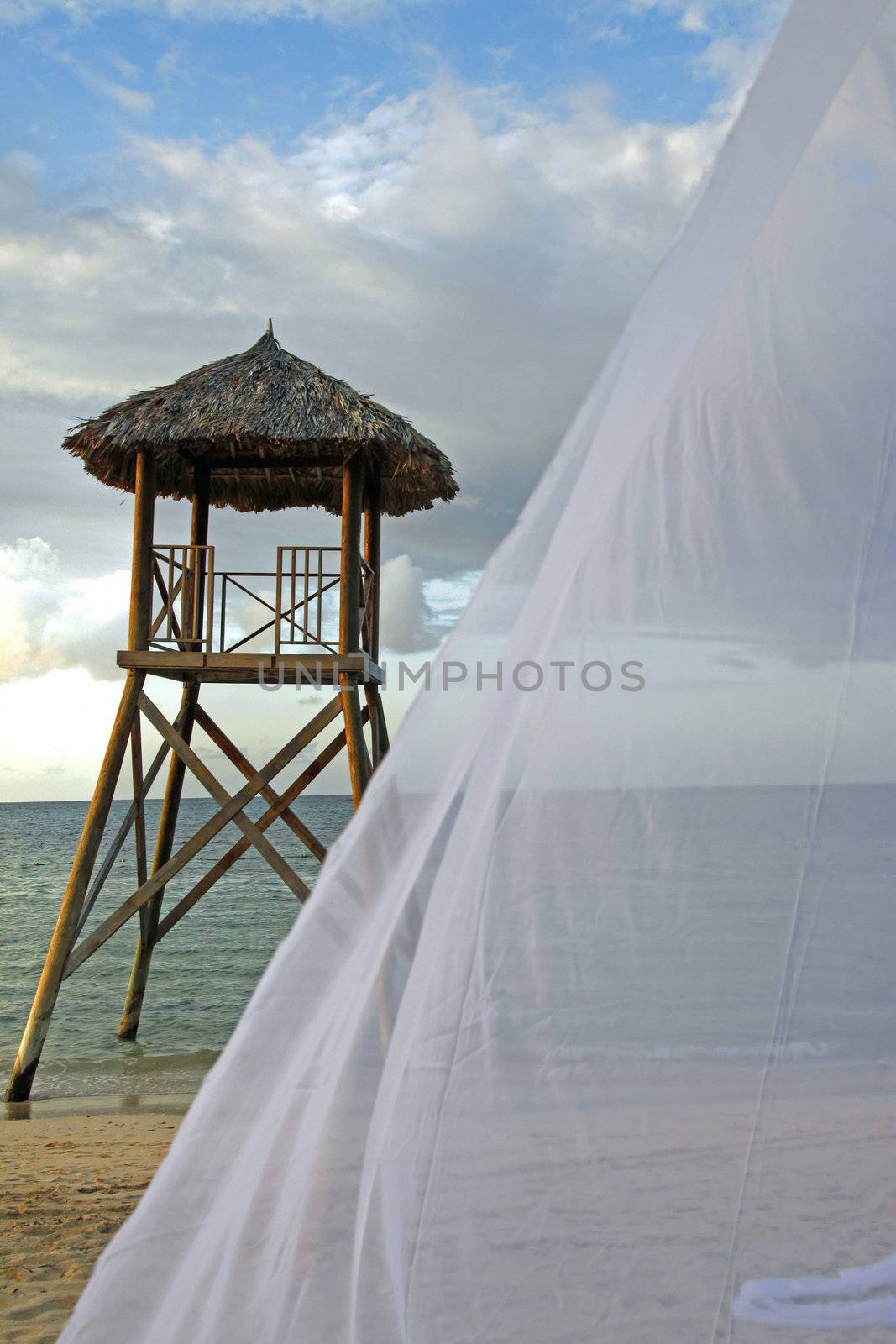 Tropical watchtower overlooking a beach wedding set up