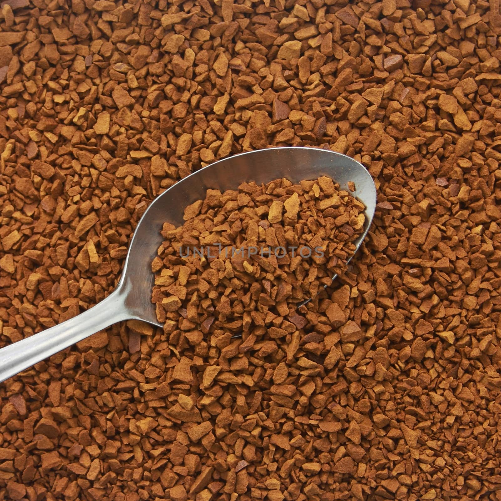 Spoon of coffee at coffee background