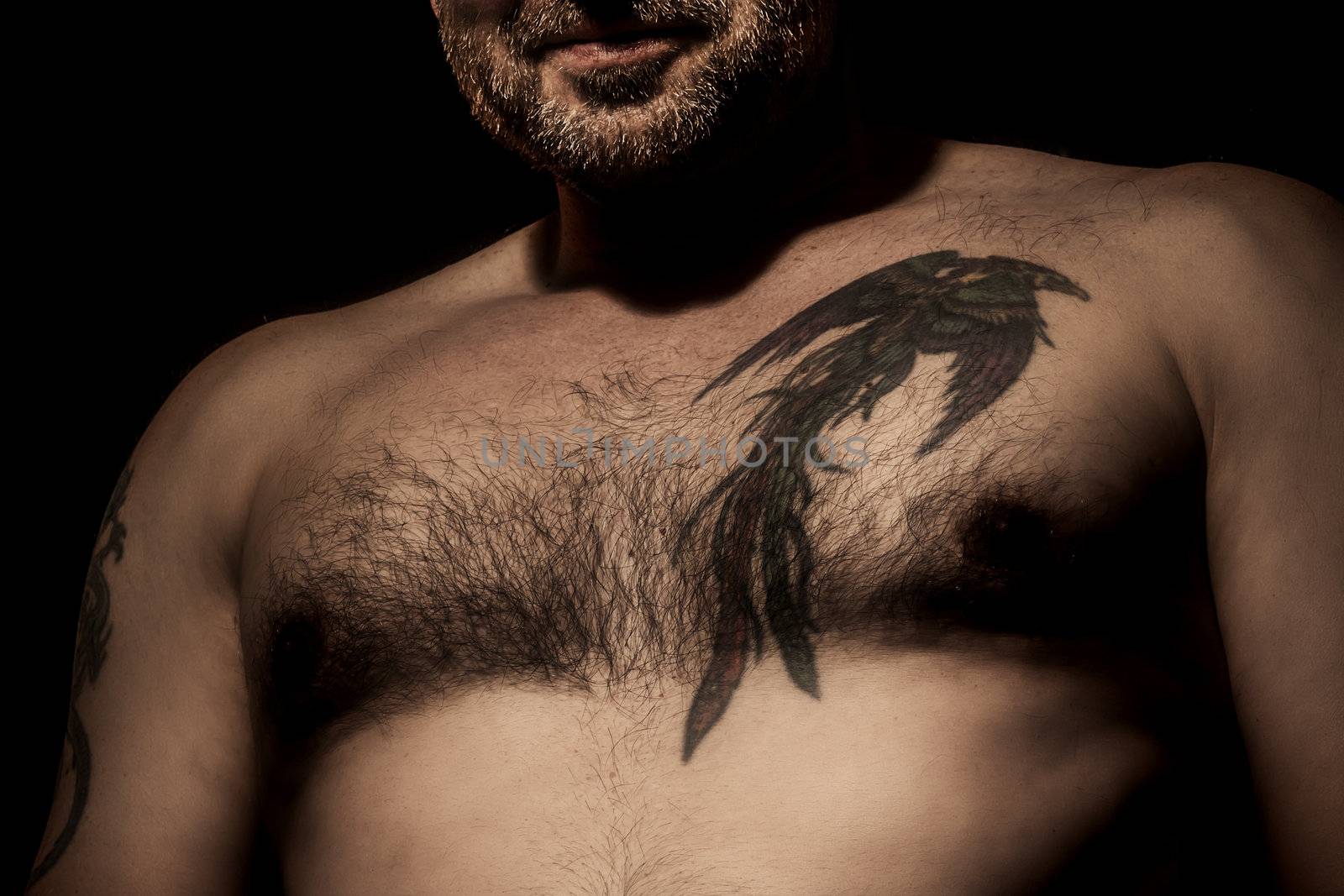 An image of a handsome man with a tattoo