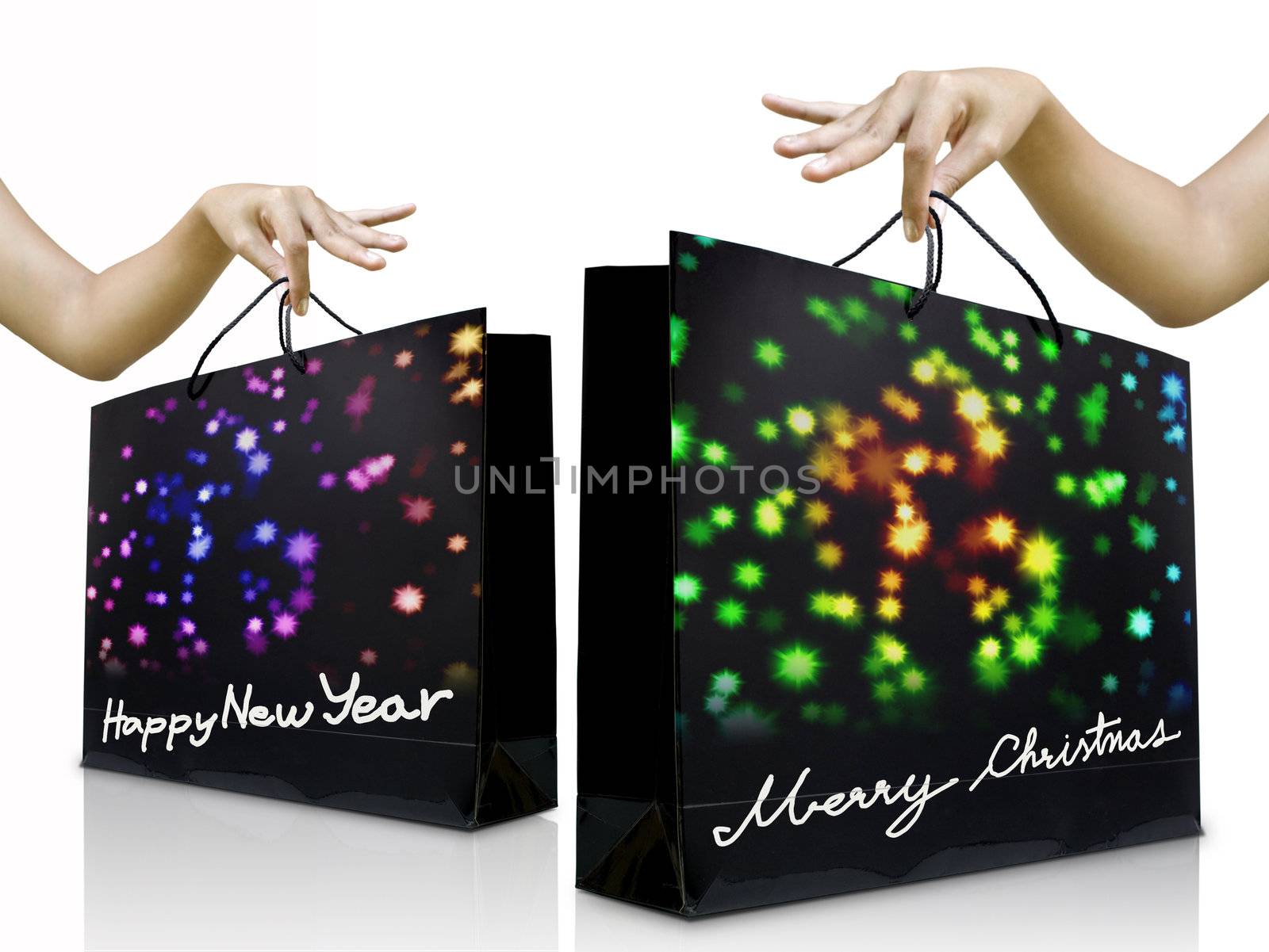 Girl hand pick up the holiday shopping bag by pixbox77