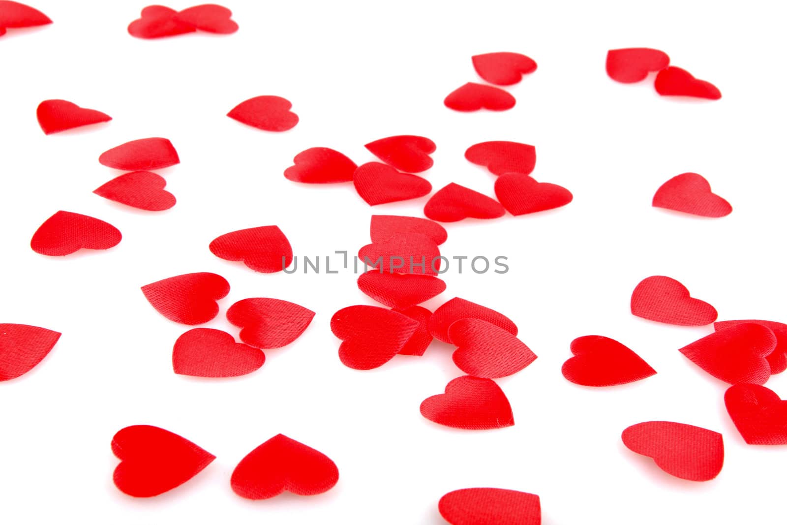 Red hearts confetti on white background