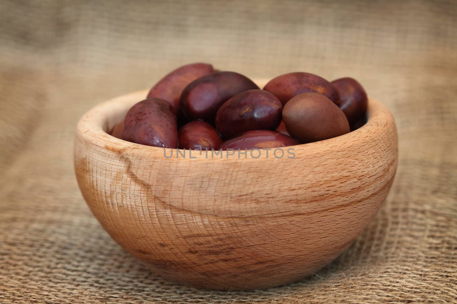 Some olives in bowl close up , shallow DOF