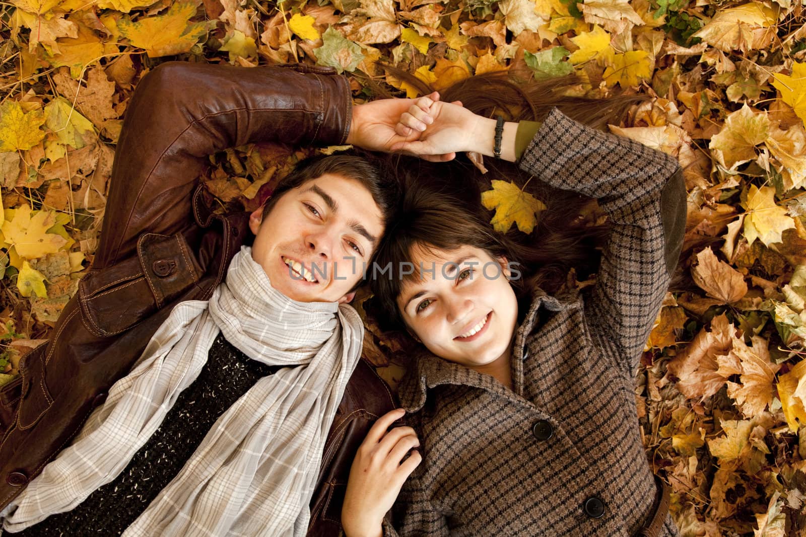 Couple lying in the park in fall by masson