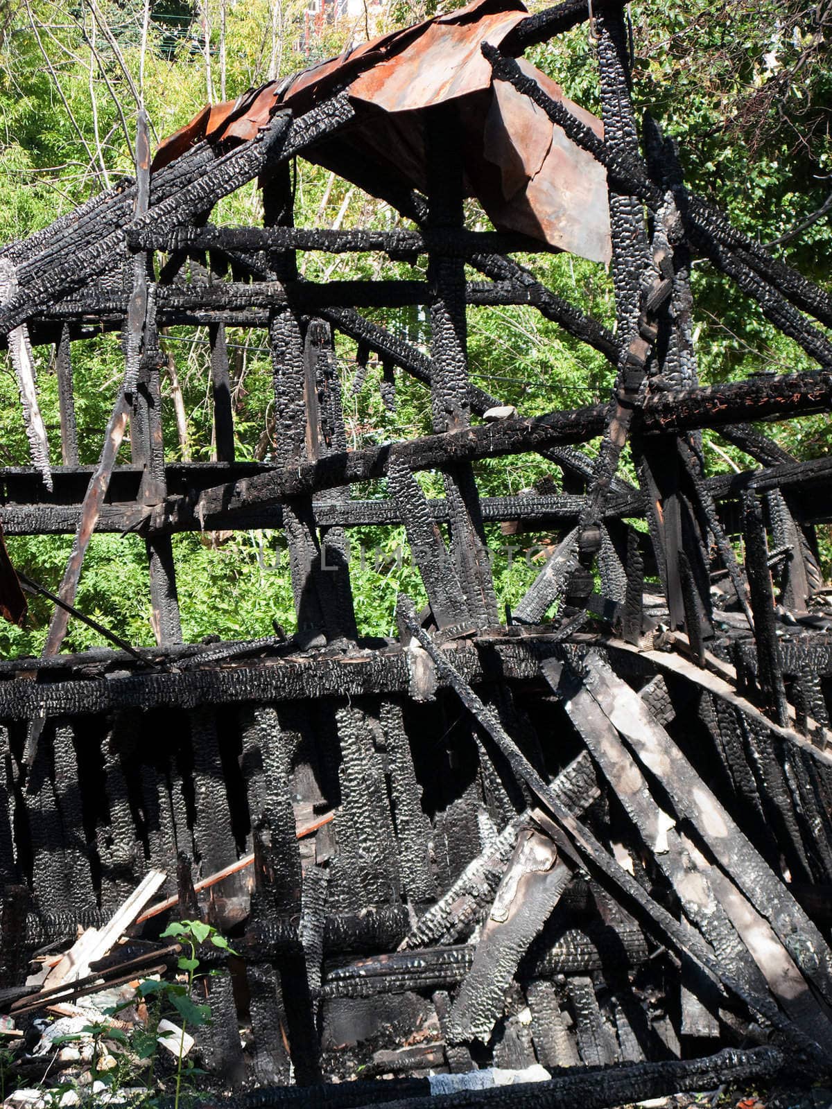 Ruined wood log house burnt by fire to black coal