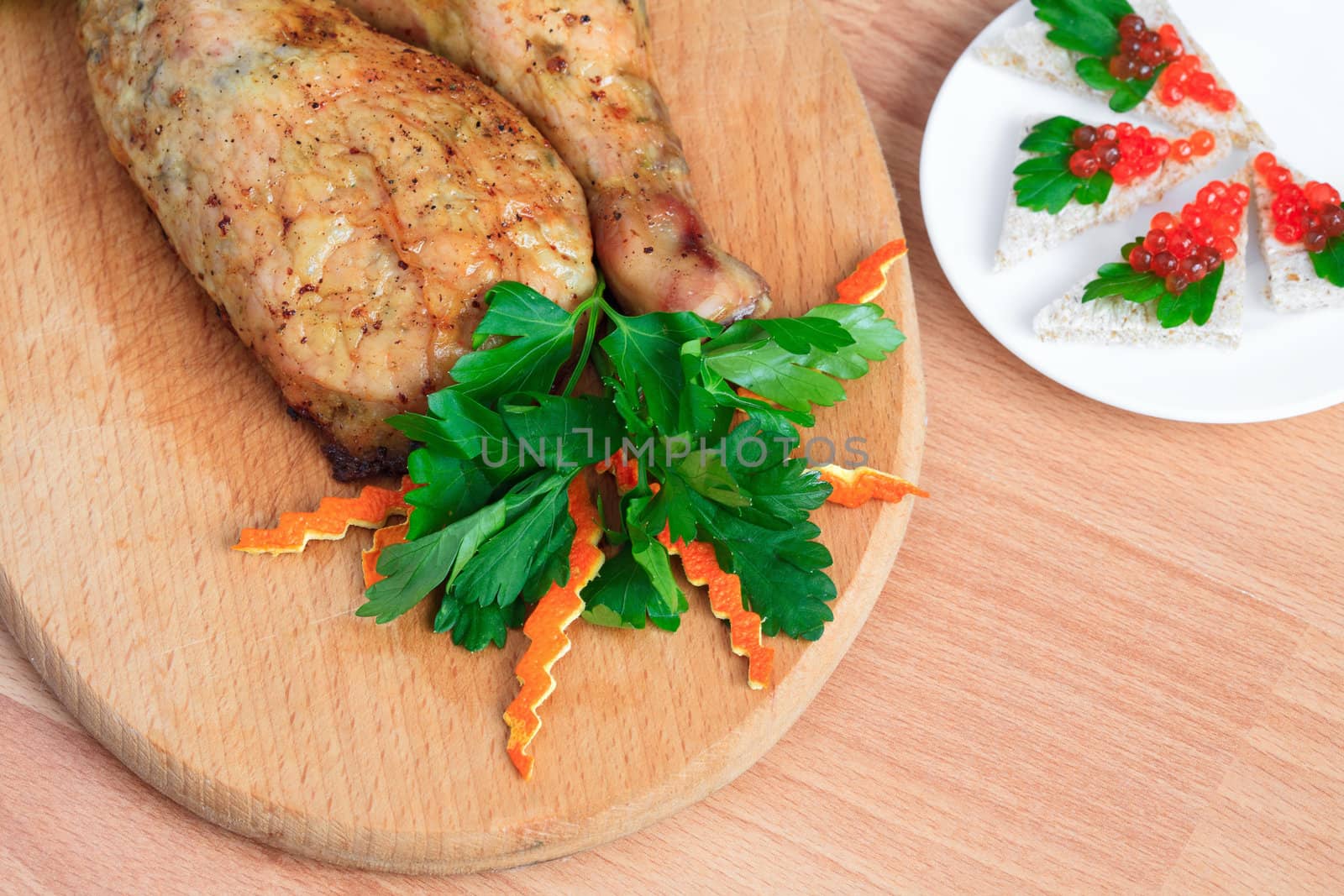 Fried chicken legs with parsley and red caviar