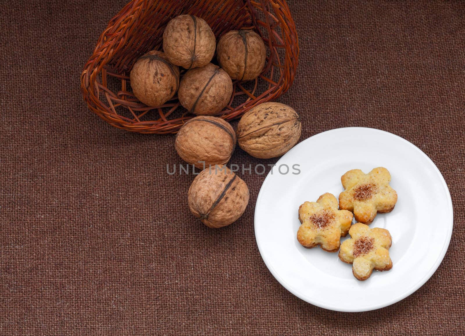 wicker basket with nuts and pastry on a plate