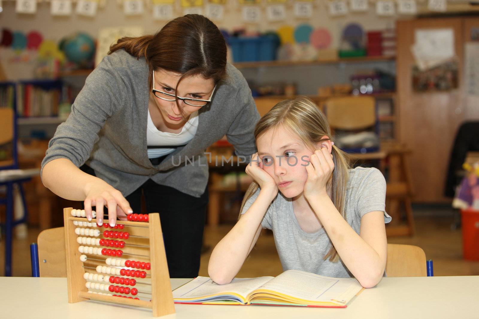 a teacher and pupil count together in school - horizontally