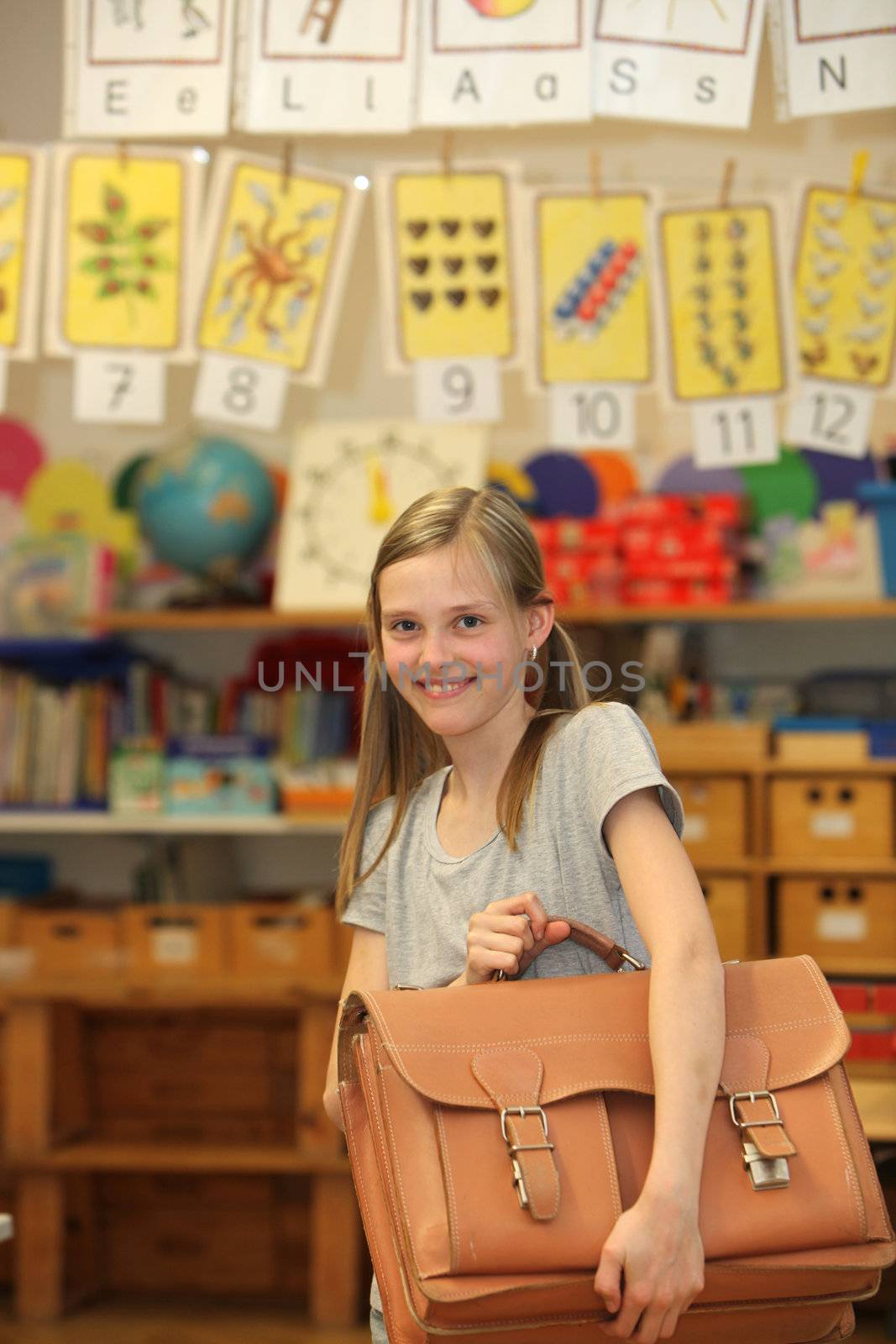Happy girl at school with school bag. by Farina6000