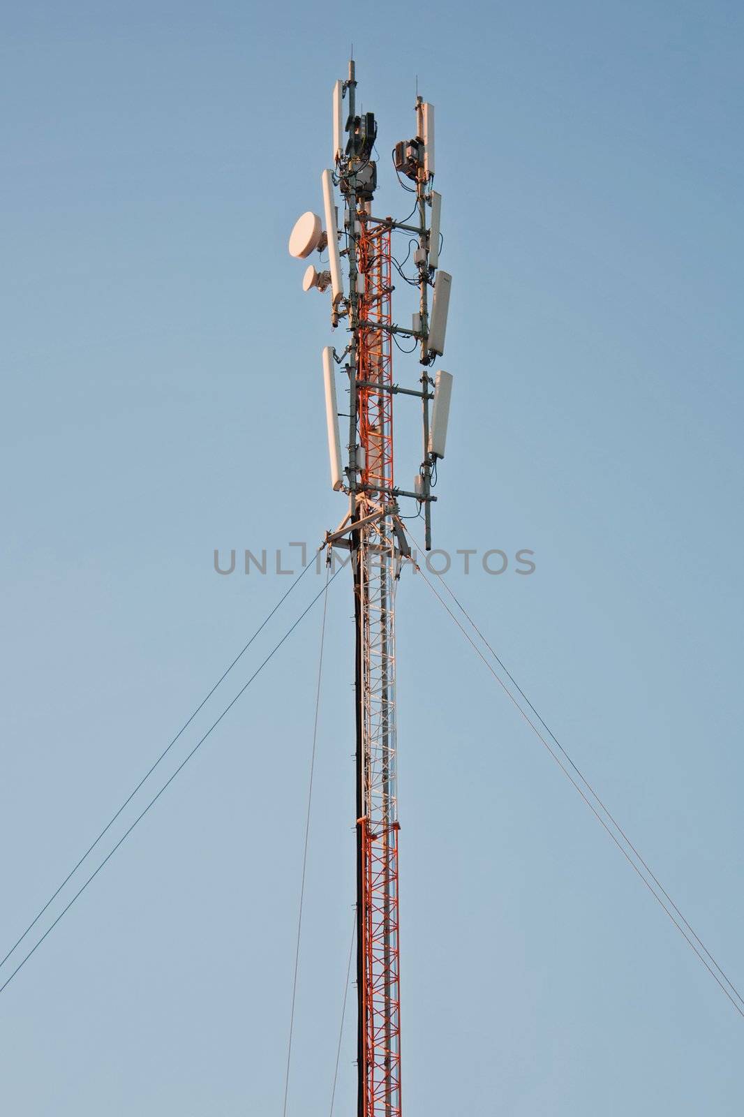 Communications antenna tower with repeater equipment