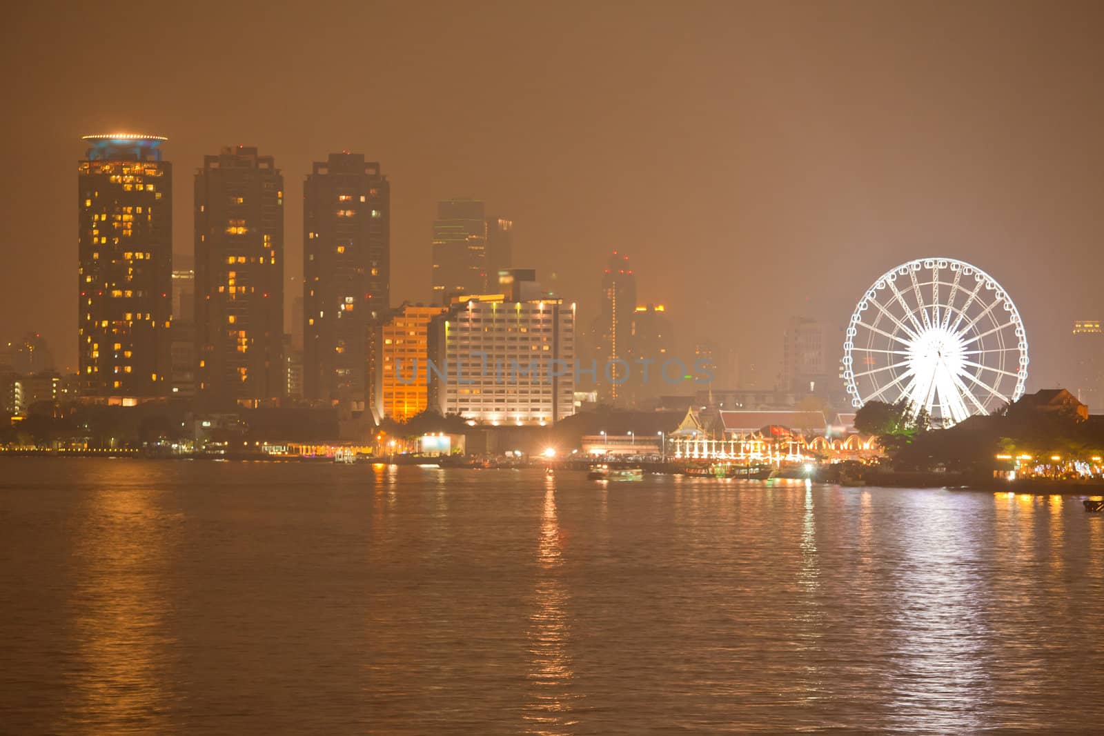 Ferris Wheel and night river in Bangkok, Thailand