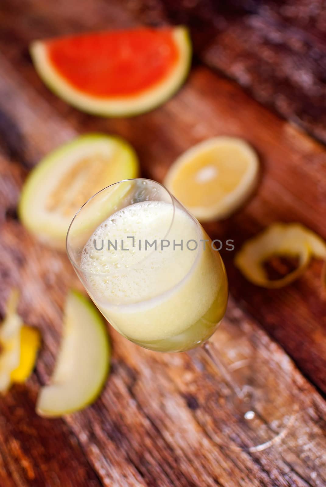 healthy juice made of freshly juiced fruits over wooden surface