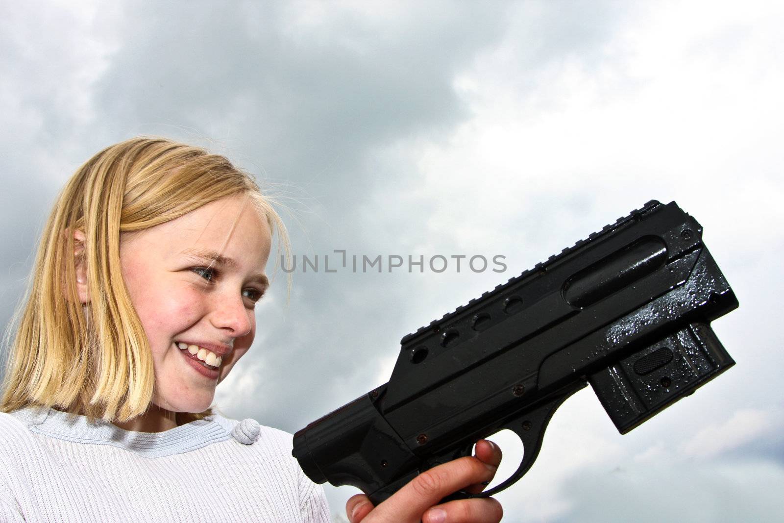 Girl playing with a gun in denmark in the summer