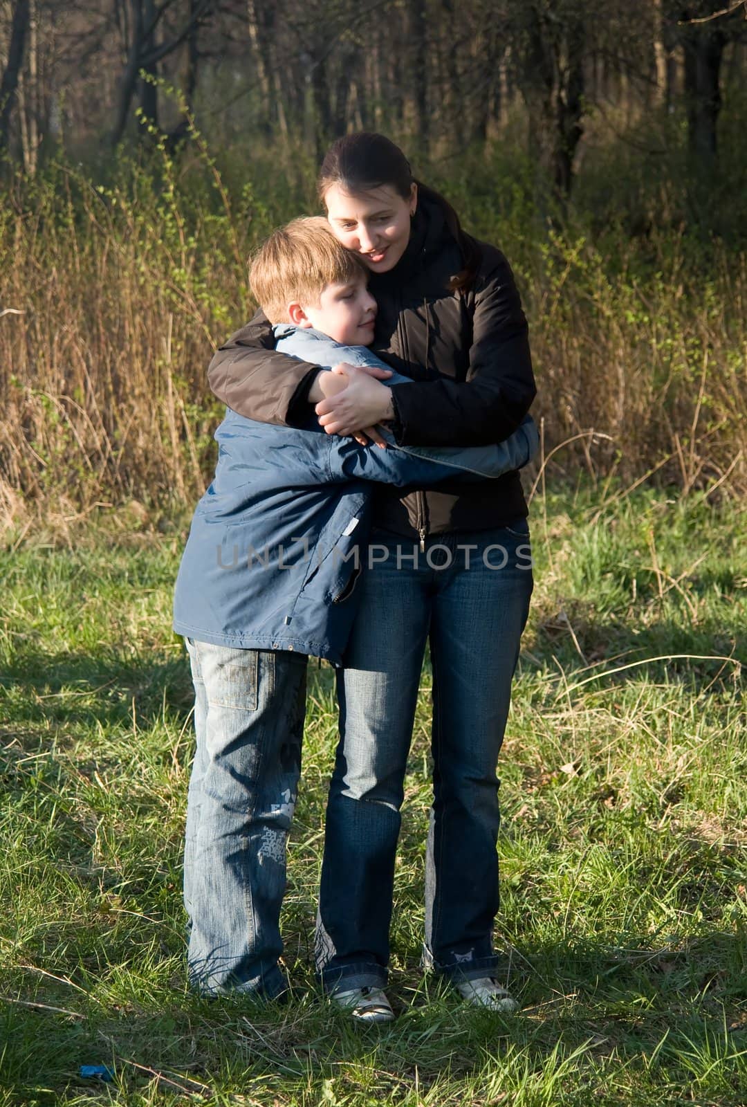 Mum and the son in autumn park.