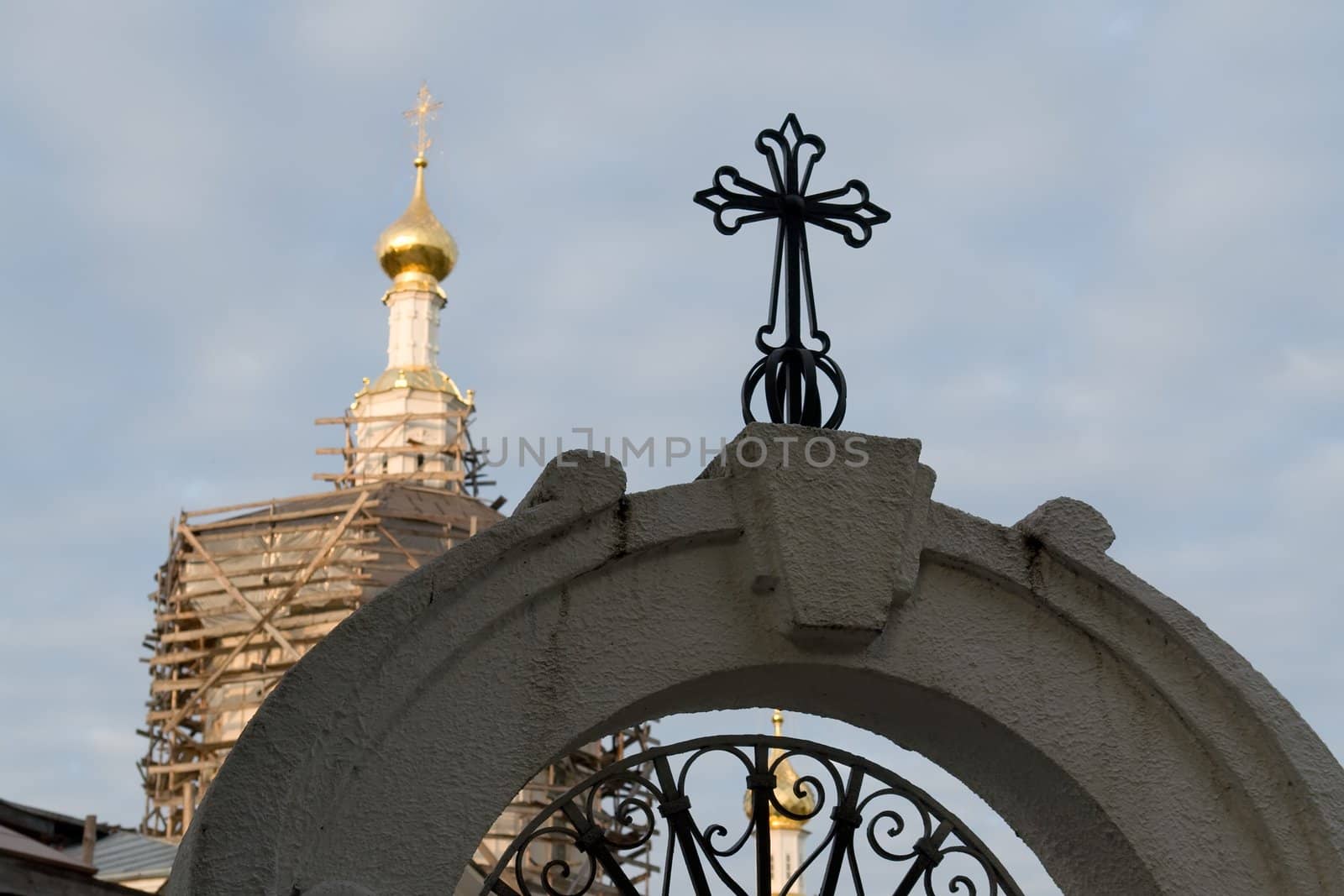 crosses on the cupolas of orthodox temple with sky at background