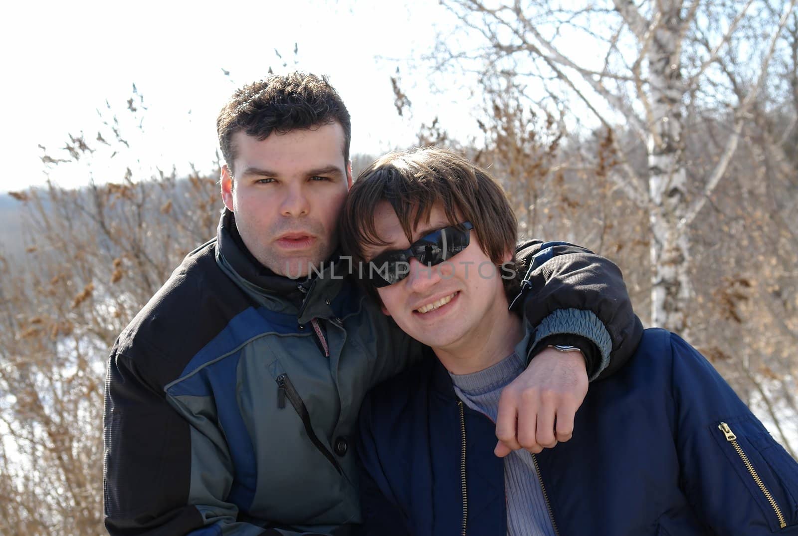 Friends. Two young men in winter park