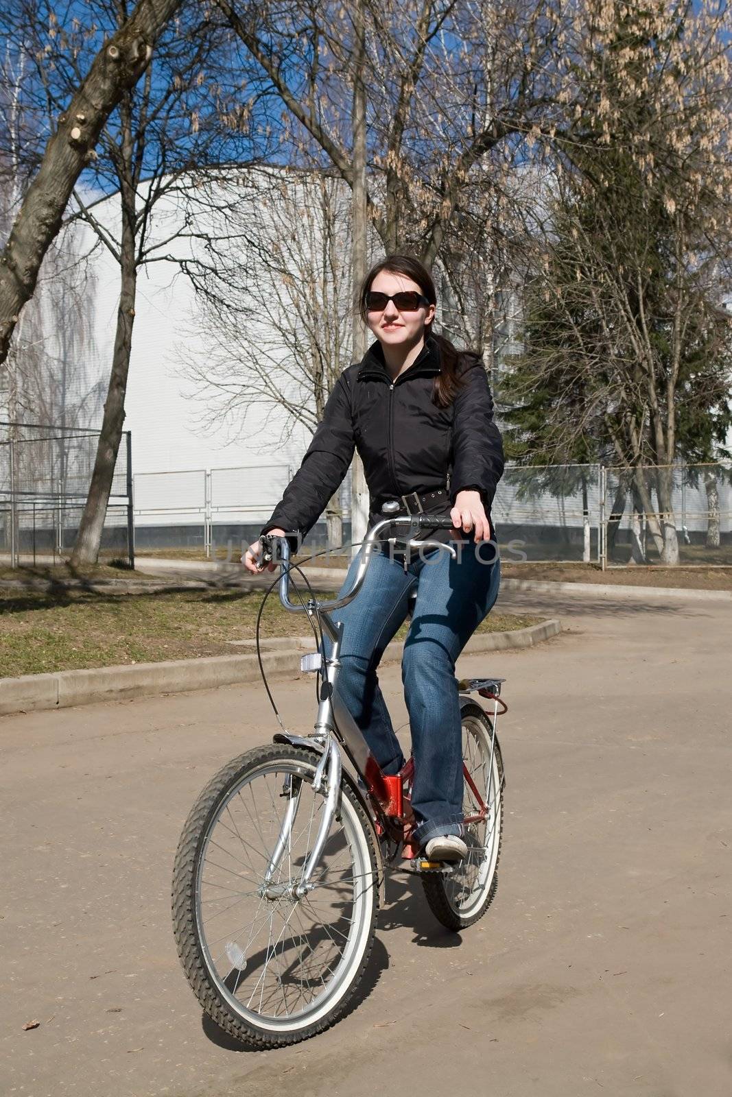 The young beautiful woman on a bicycle