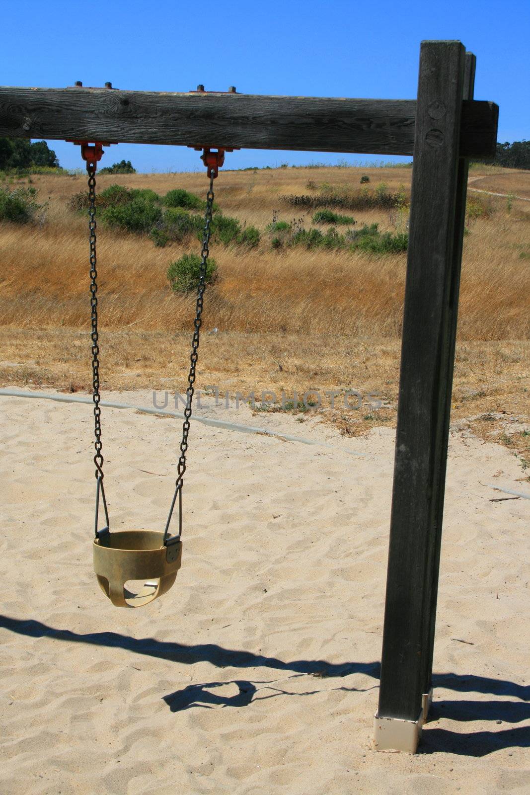 Close up of swings in a playground.
