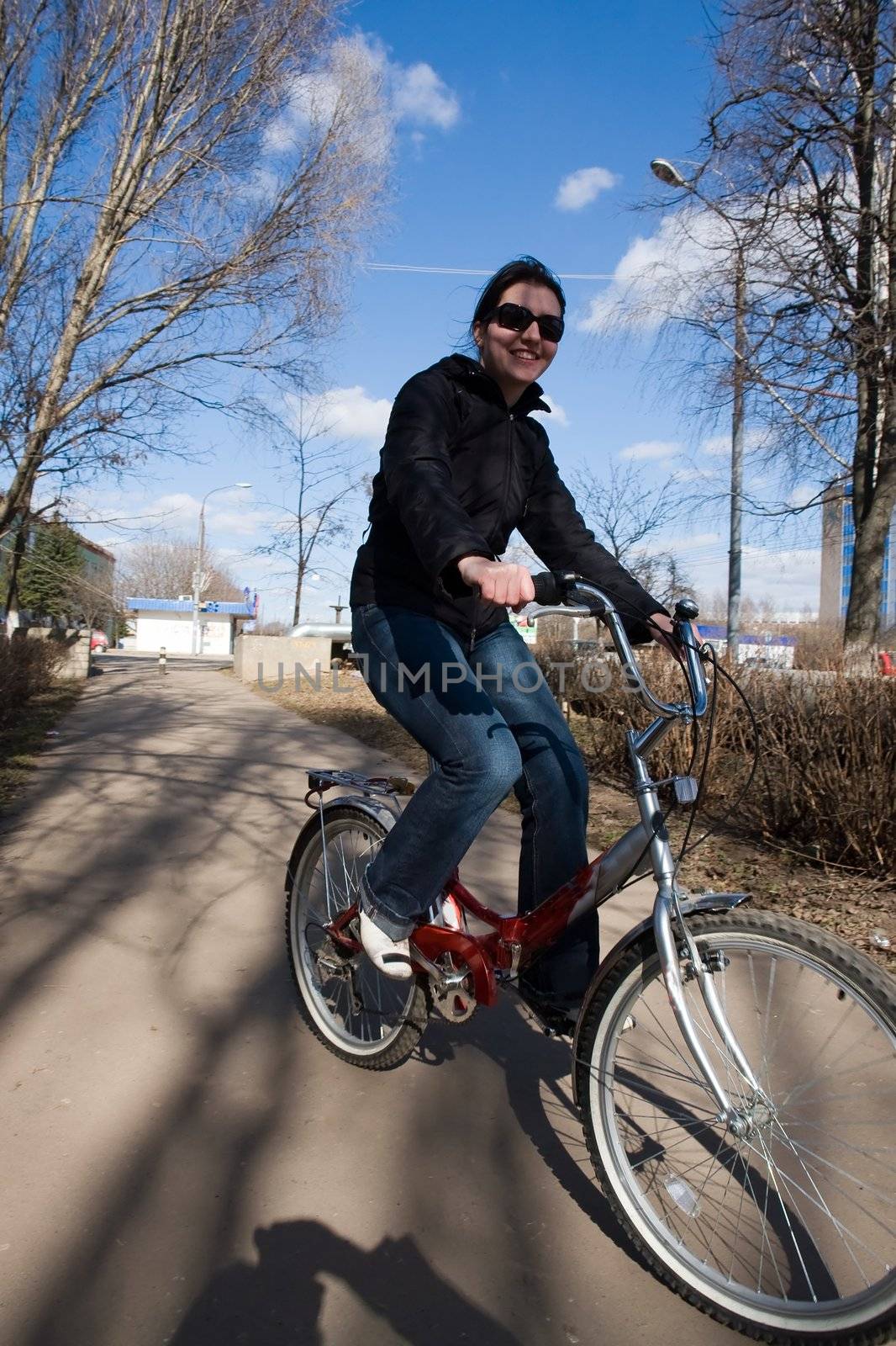 The young beautiful woman on a bicycle