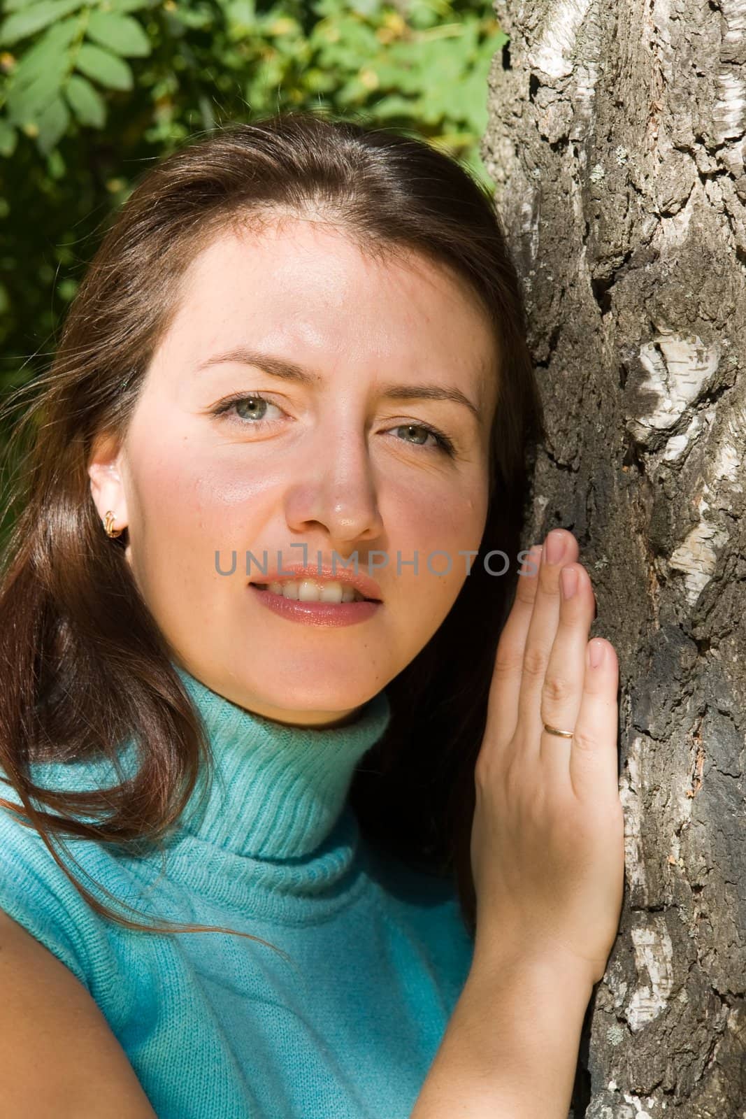 Portrait. The beautiful young woman near a birch.