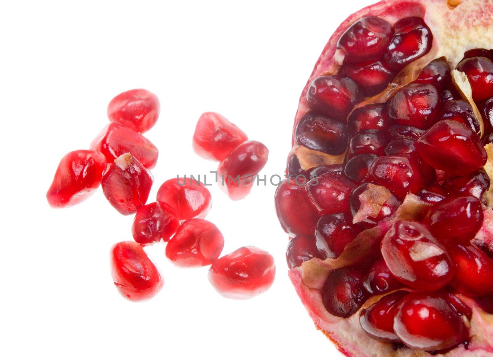 macro close-up of cut red fresh pomegranate in white background

