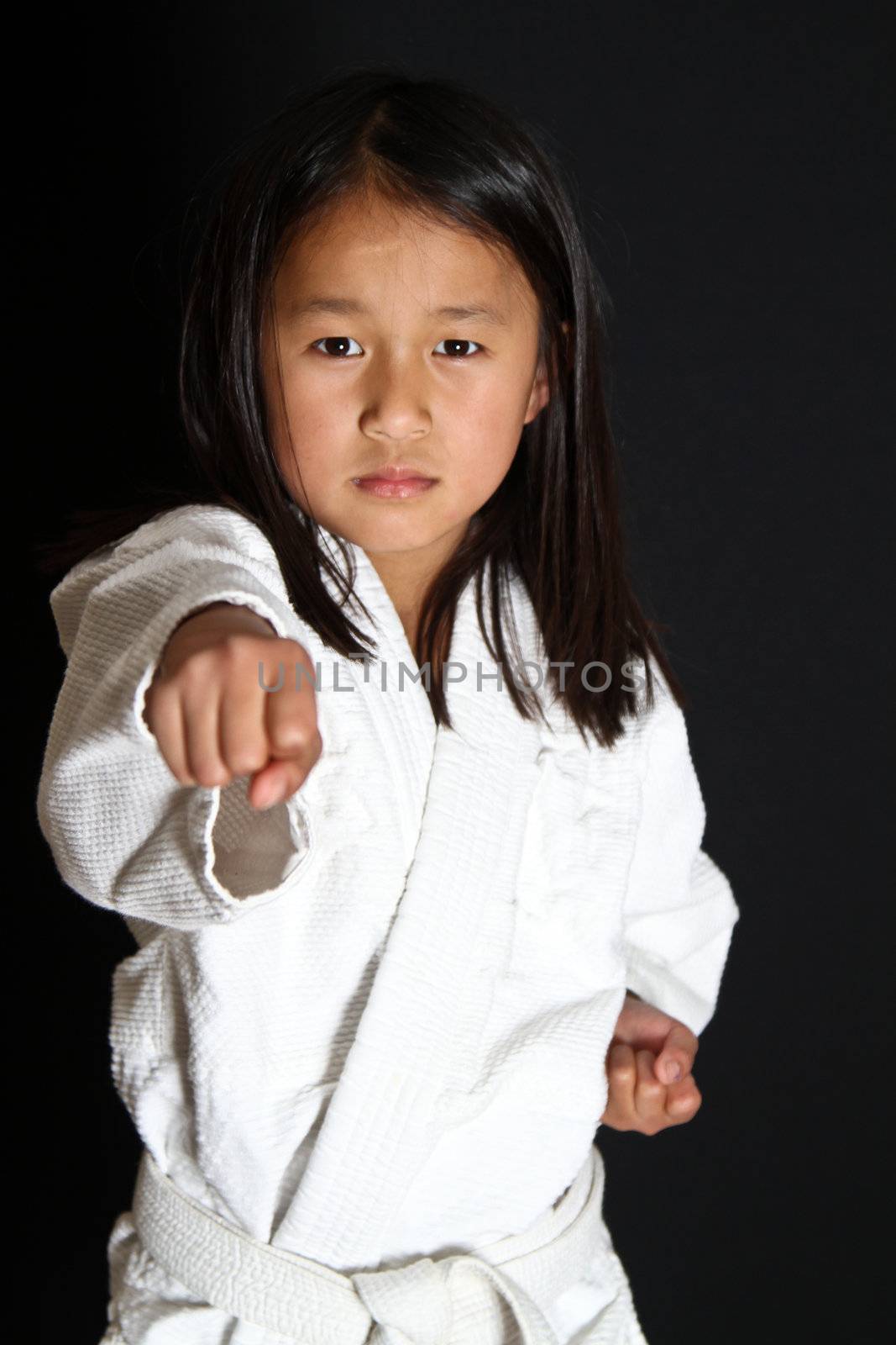 Cute asian small girl in kimono looking at the camera