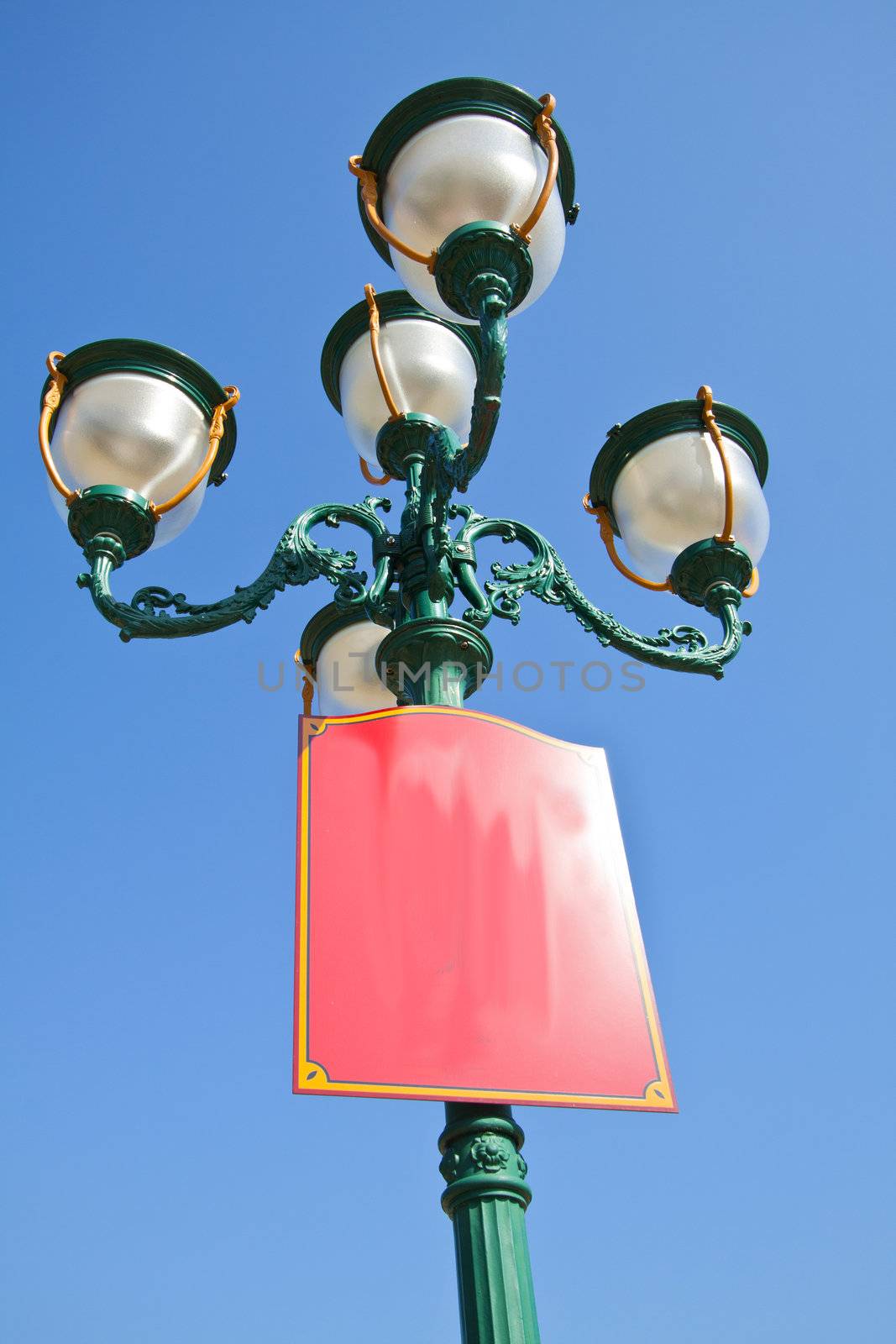 Green lamp under blue sky