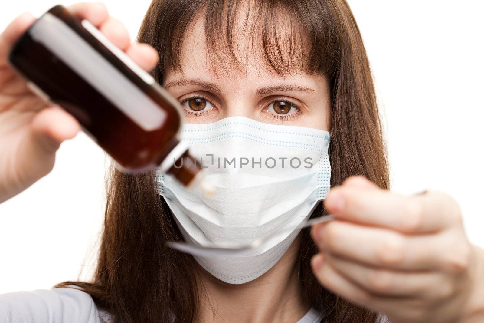 Doctor in mask holding medicine syrup by ia_64