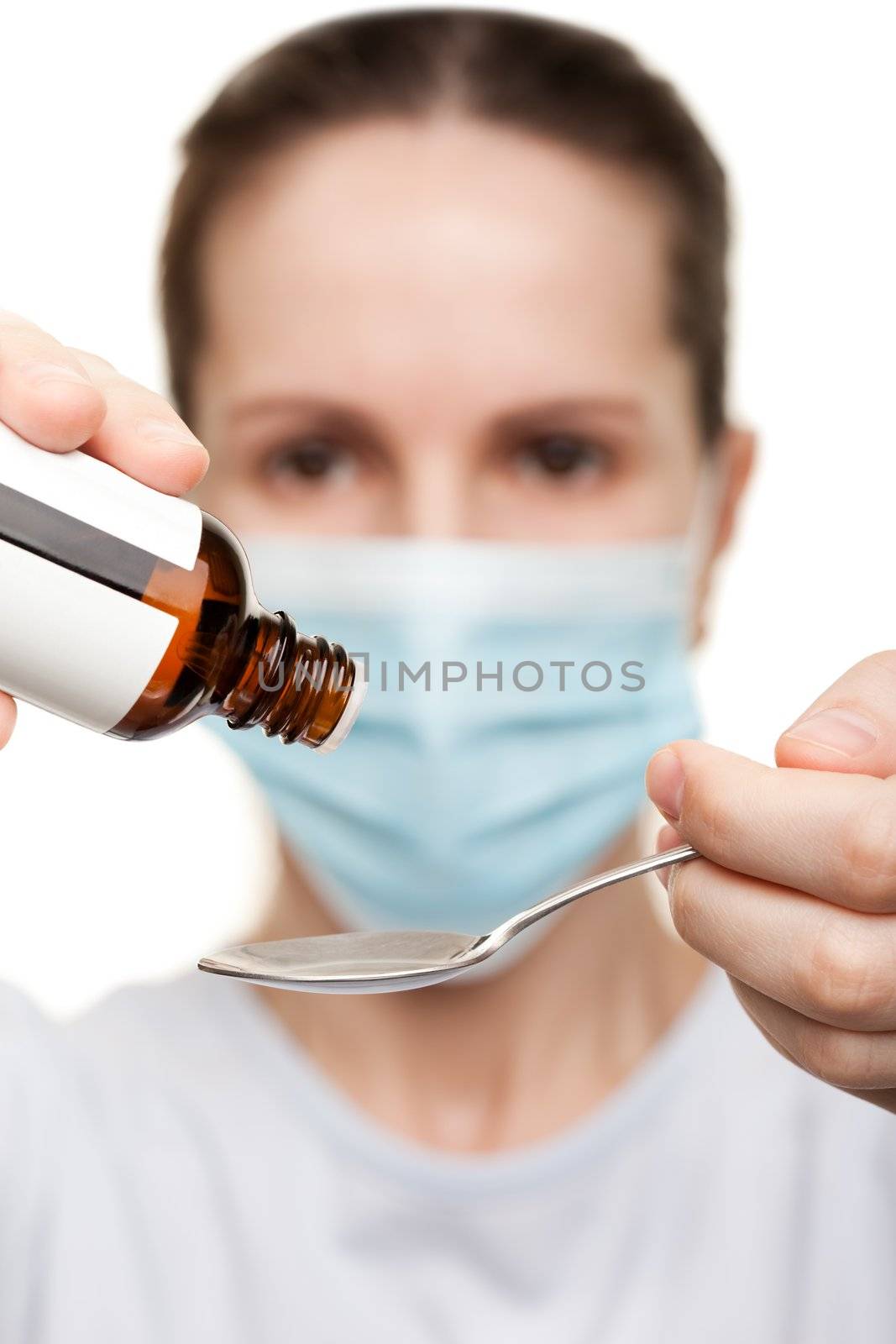 Doctor in mask holding medicine syrup by ia_64