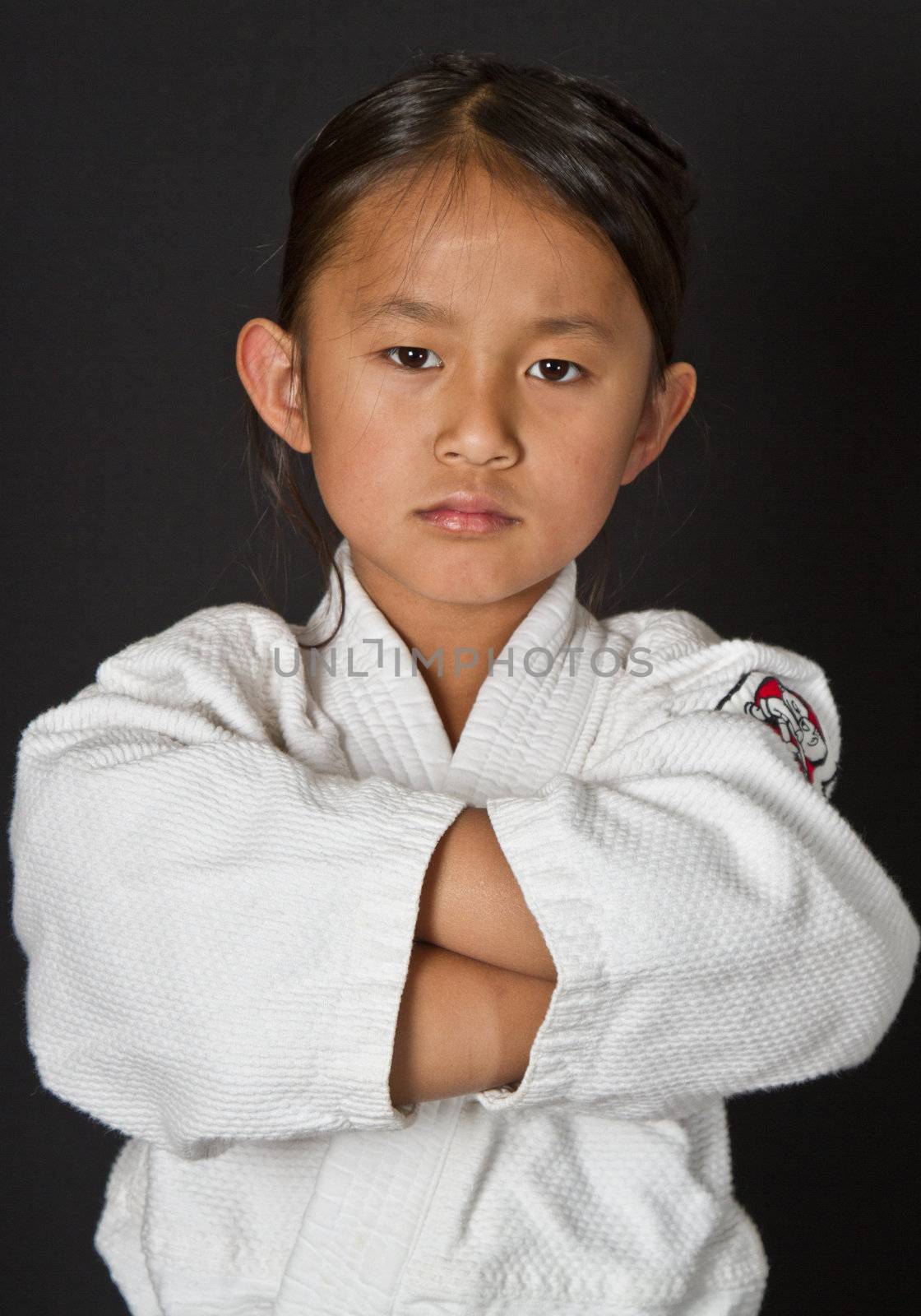 Cute asian small girl in kimono looking at the camera