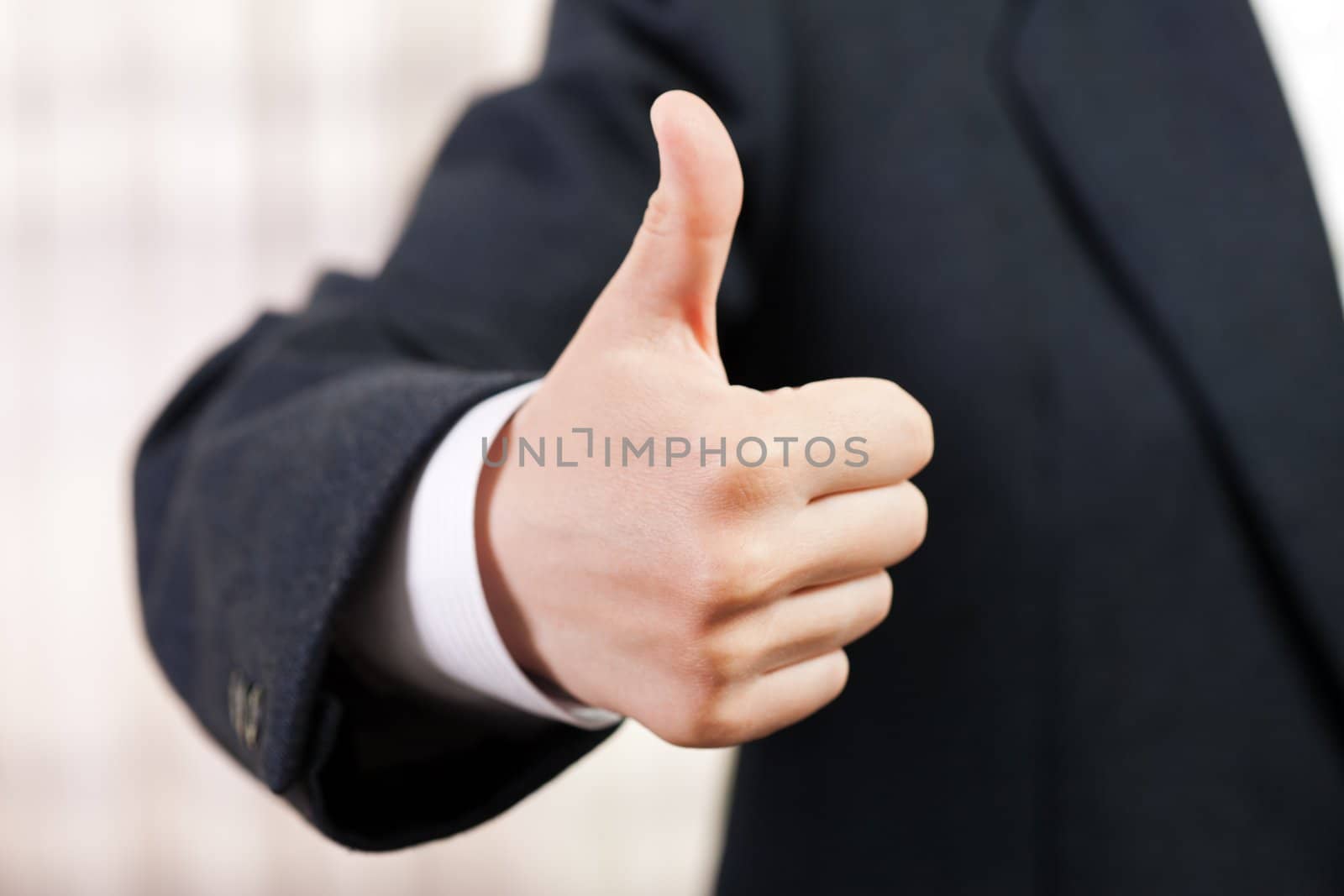 Business men hand gesturing thumb up success sign