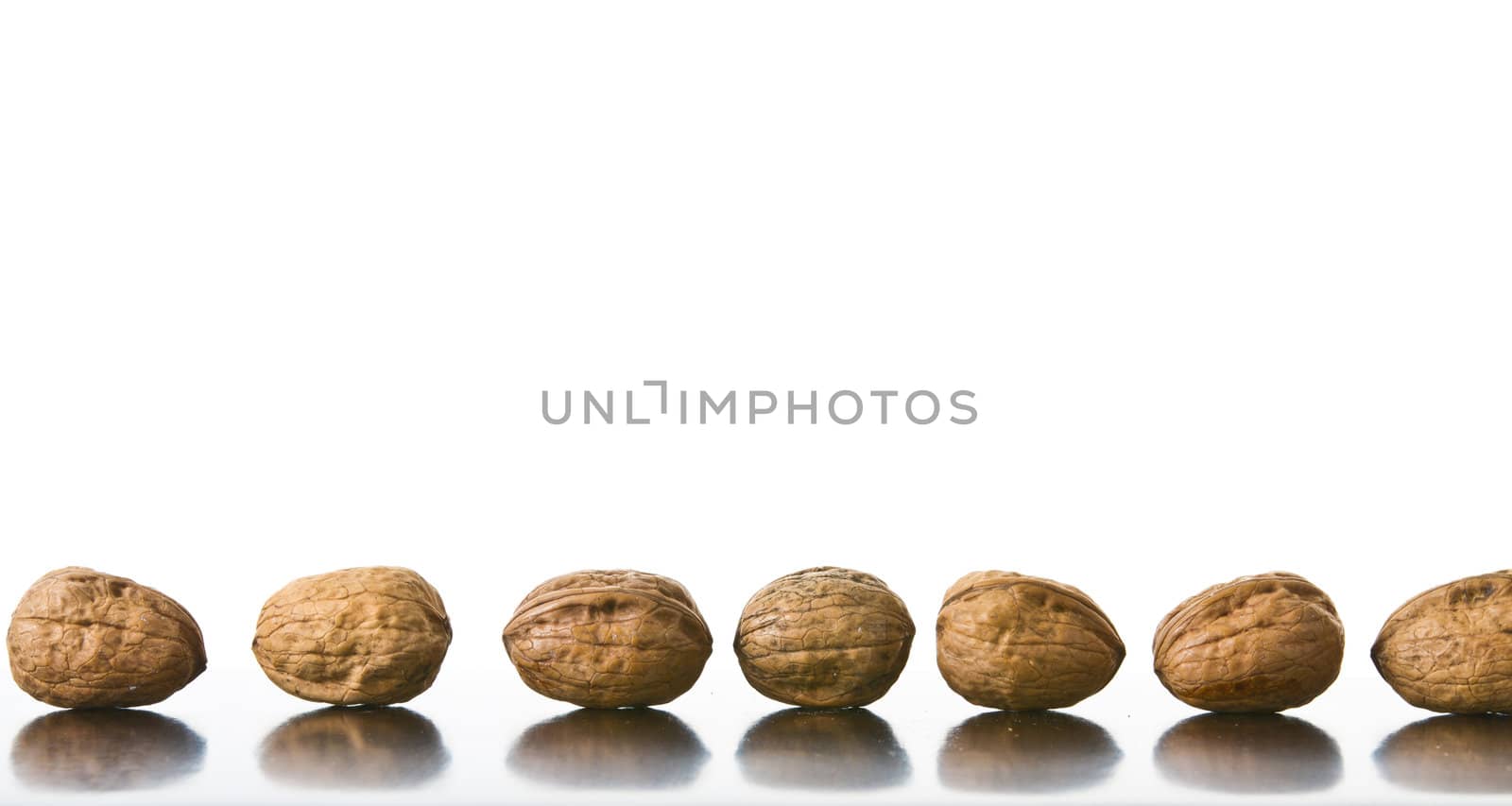 Many nuts placed on a reflecting surface