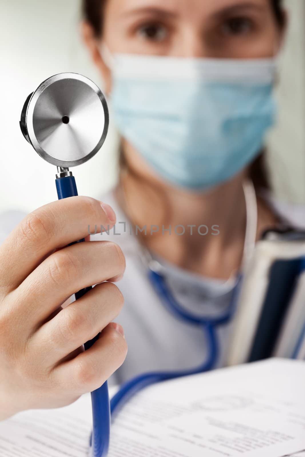 Doctor holding stethoscope by ia_64