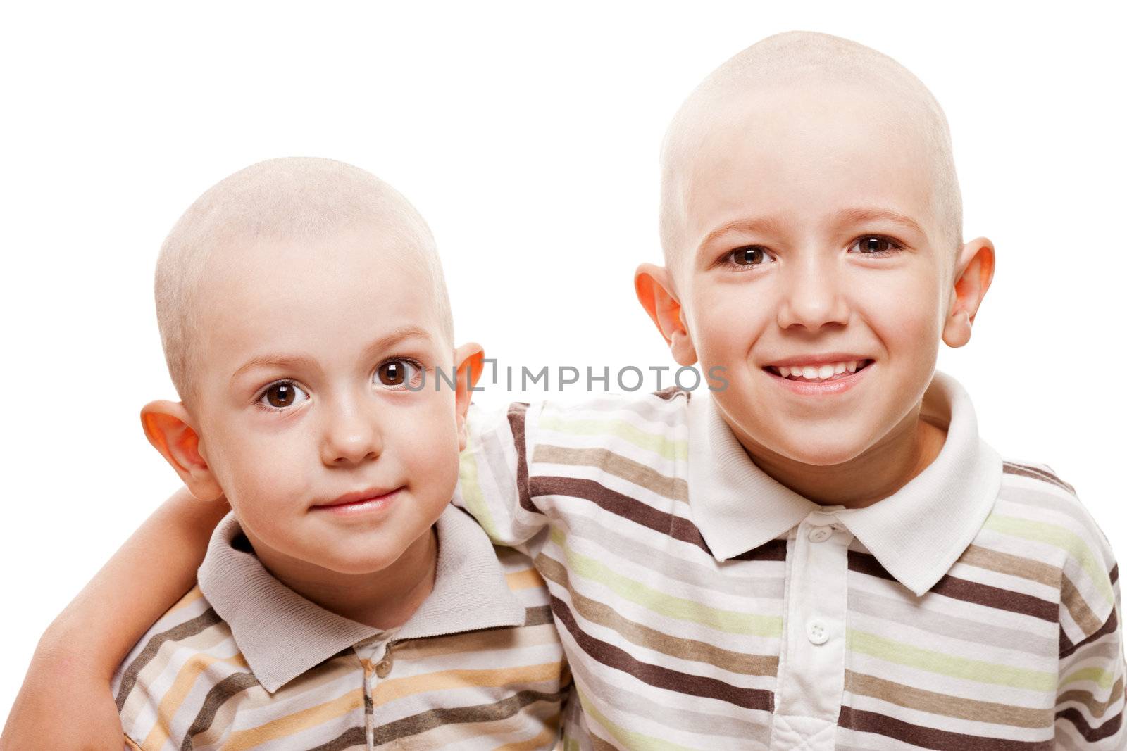 Family happiness - two little smiling child boy brothers with bald shaved heads