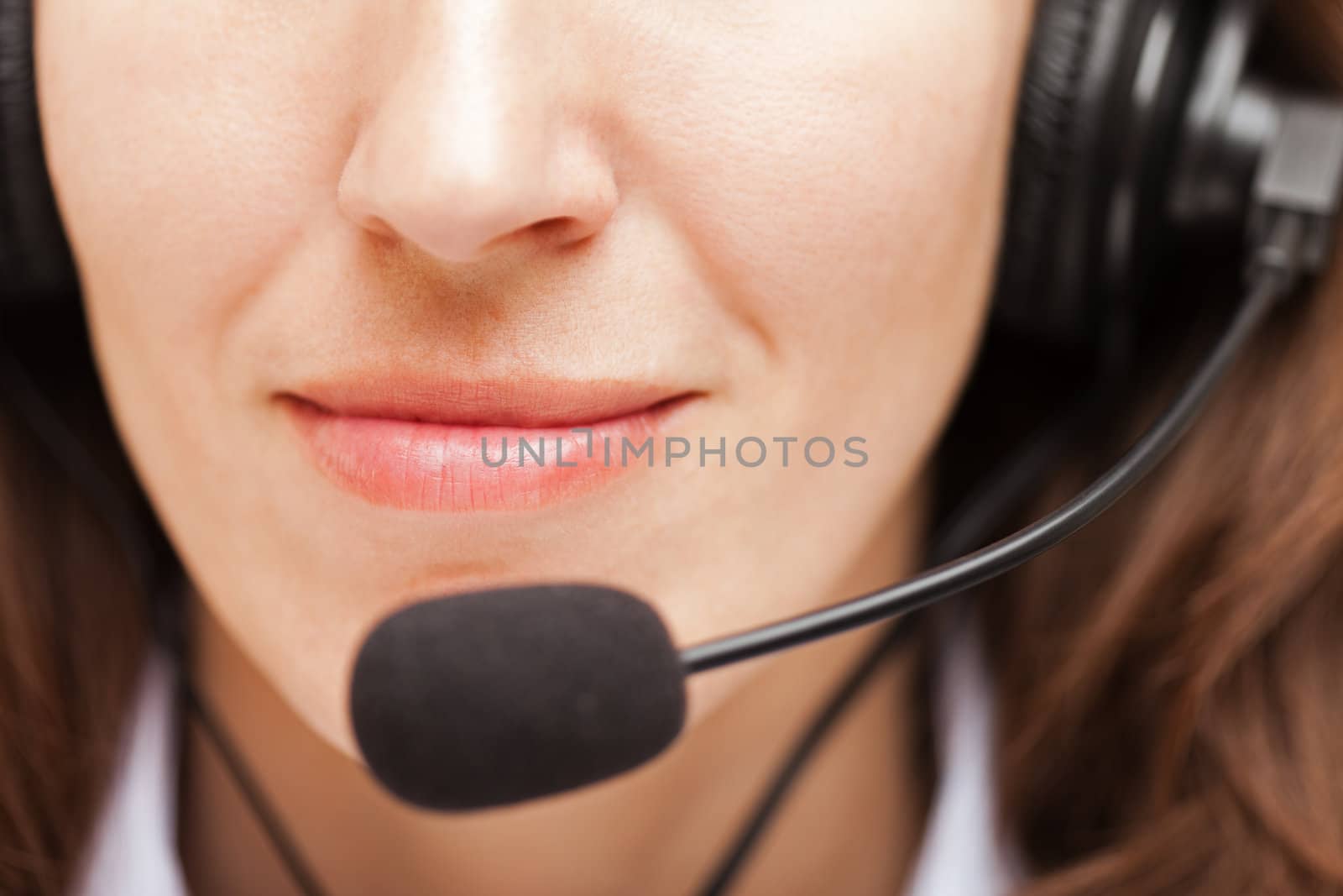 Smiling business woman with headphones or headset