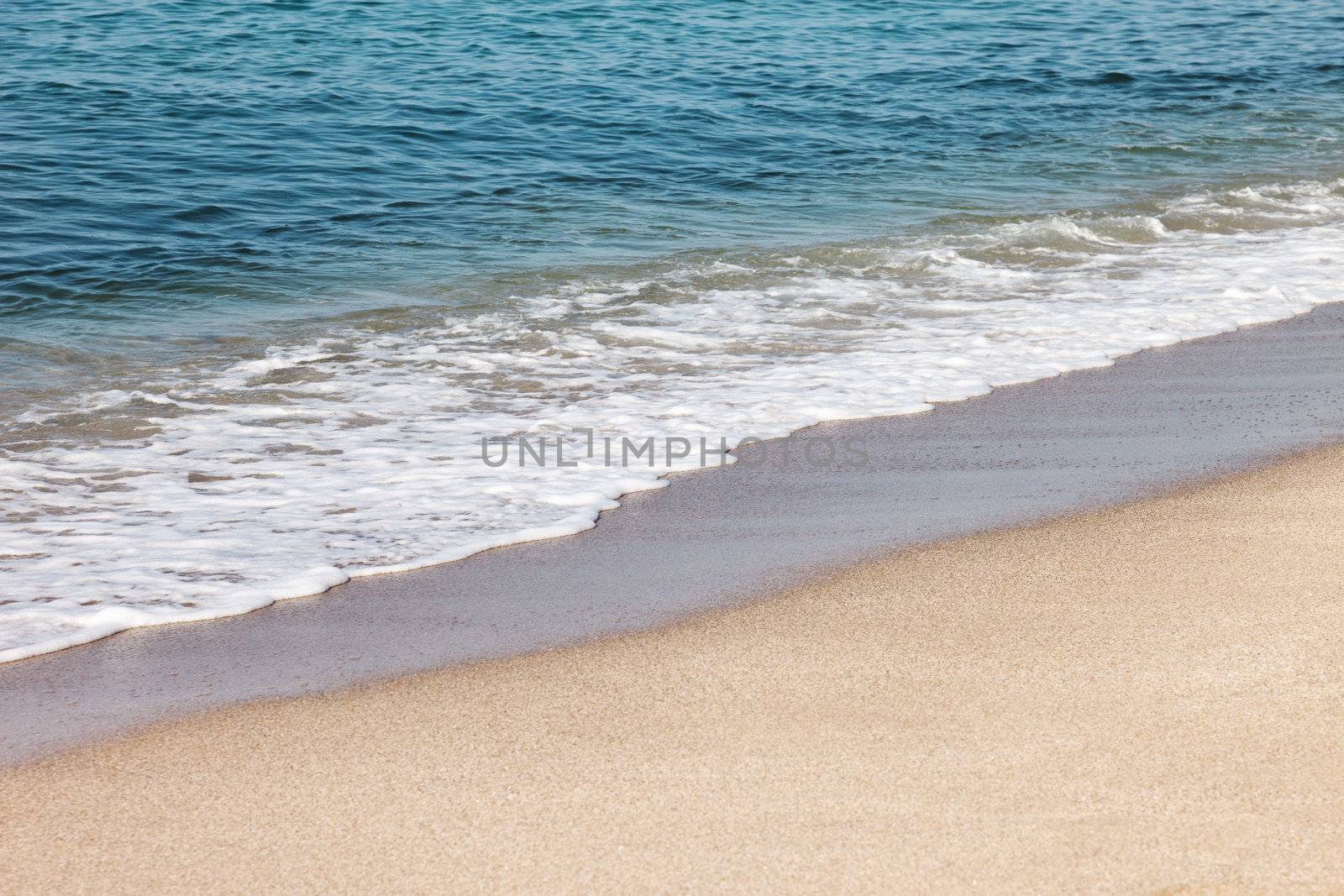 Summer vacations - blue water waves on tropical sea sand beach