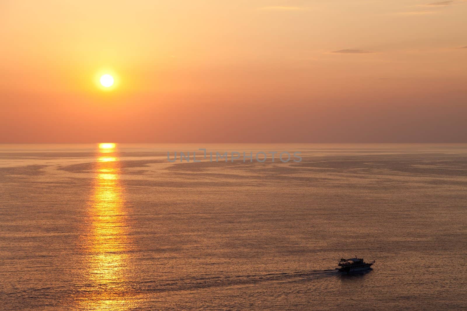 Summer vacations - water travel ship or boat sailing blue sea waves on sunset