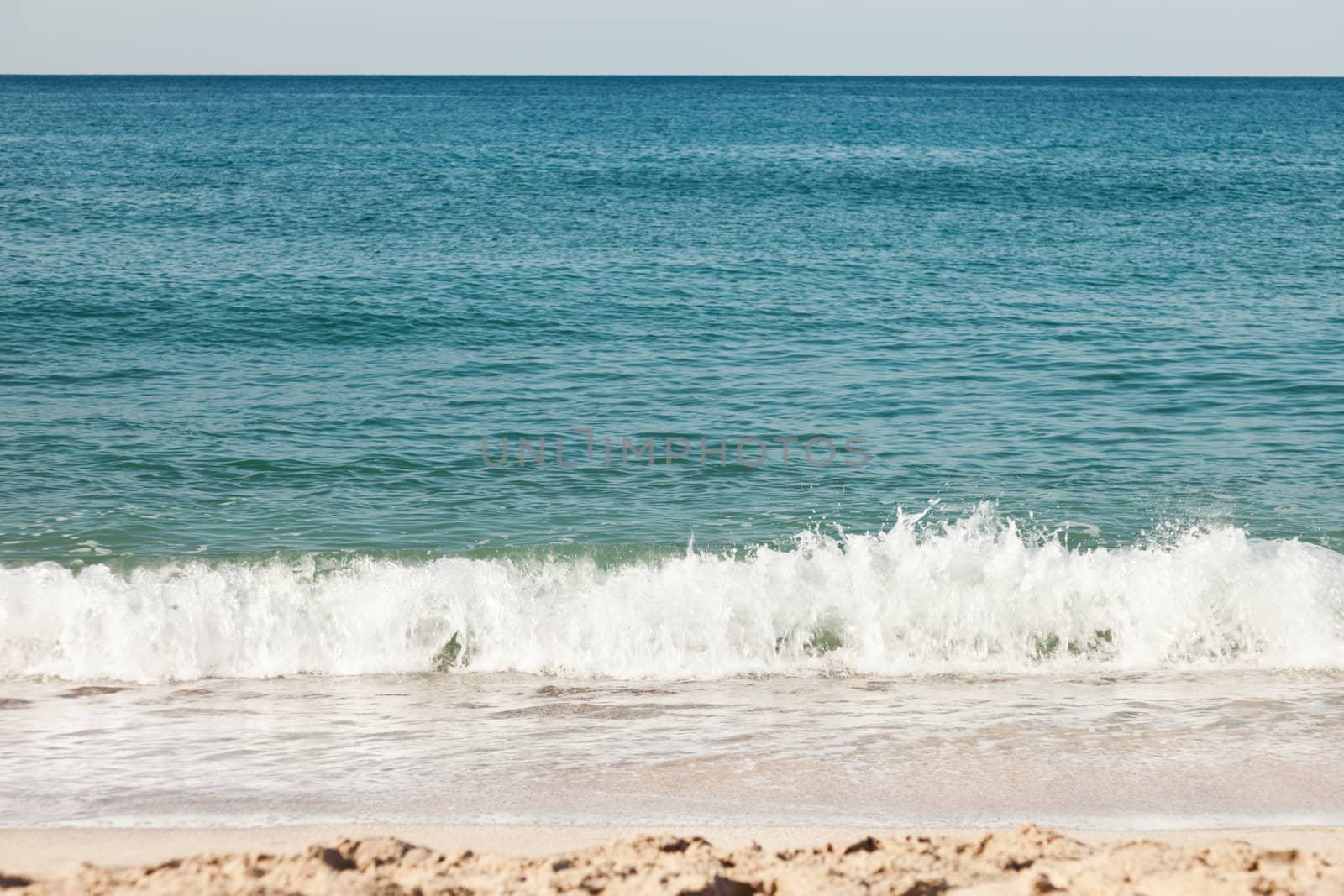 Summer vacations - blue water waves on tropical sea sand beach