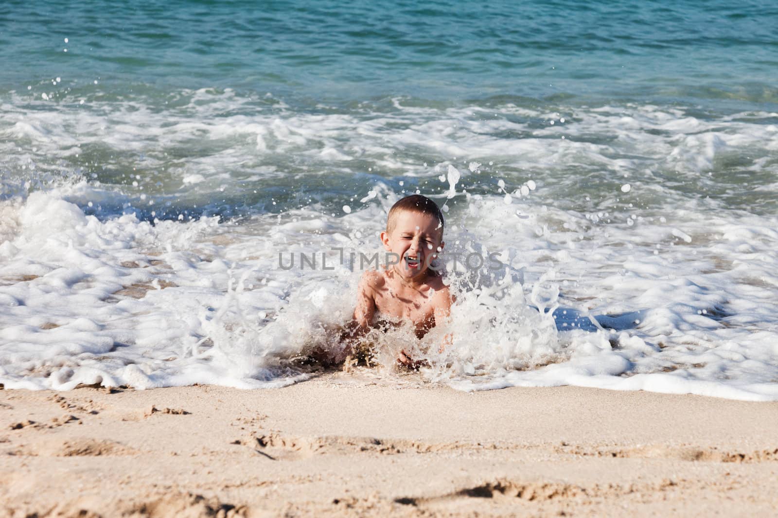 Child boy on sea beach by ia_64