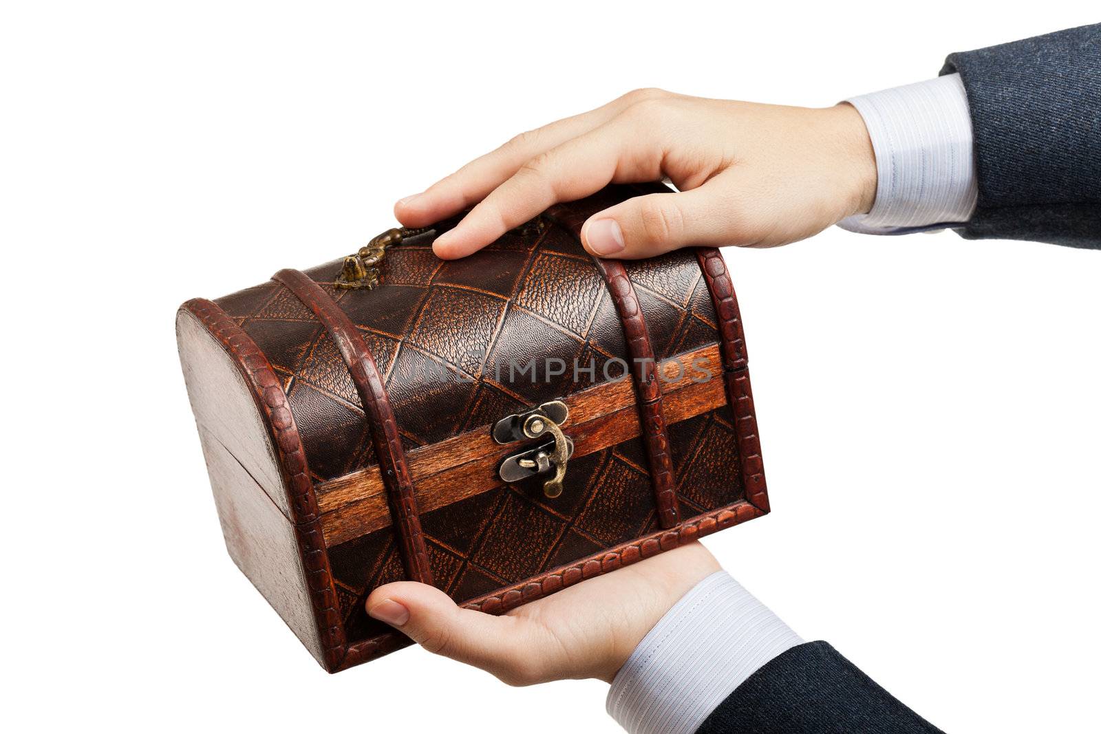 Business man hand holding old antique brown wood treasure chest or box white isolated