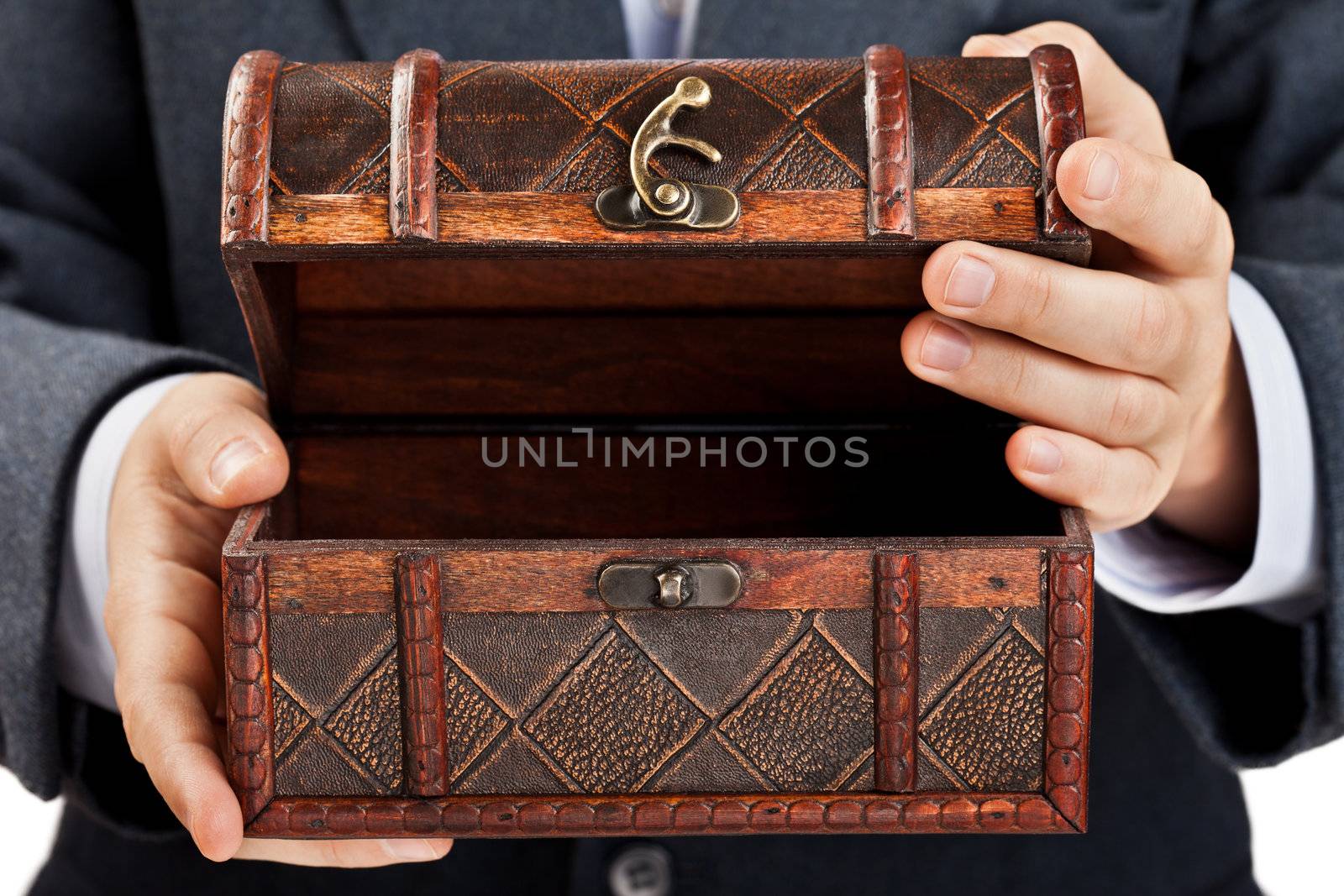 Hand holding treasure chest by ia_64